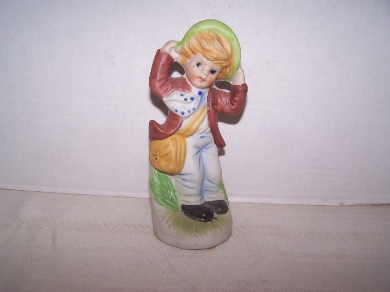 Bisque Boy Figurine Holding His Hat on a Windy Day
