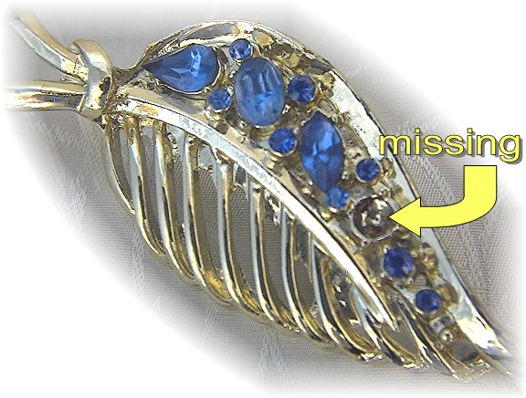 Silvertone pin with blue stones