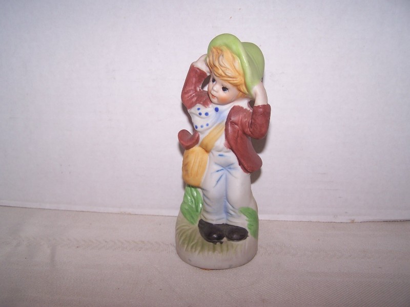 Bisque Boy Figurine Holding His Hat on a Windy Day
