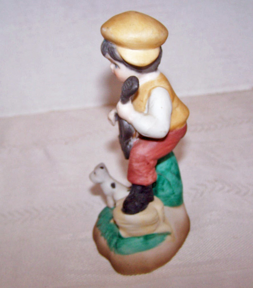 Bisque Boy Figurine with his Dog, as the Boy Plays