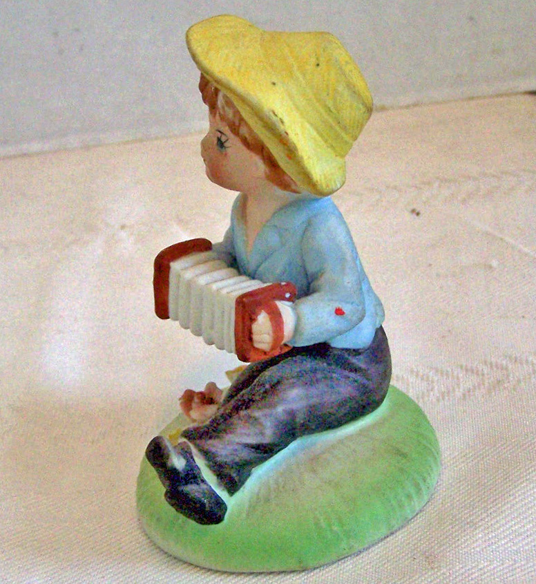 Bisque Boy Figurine Sitting & Playing the Accordion