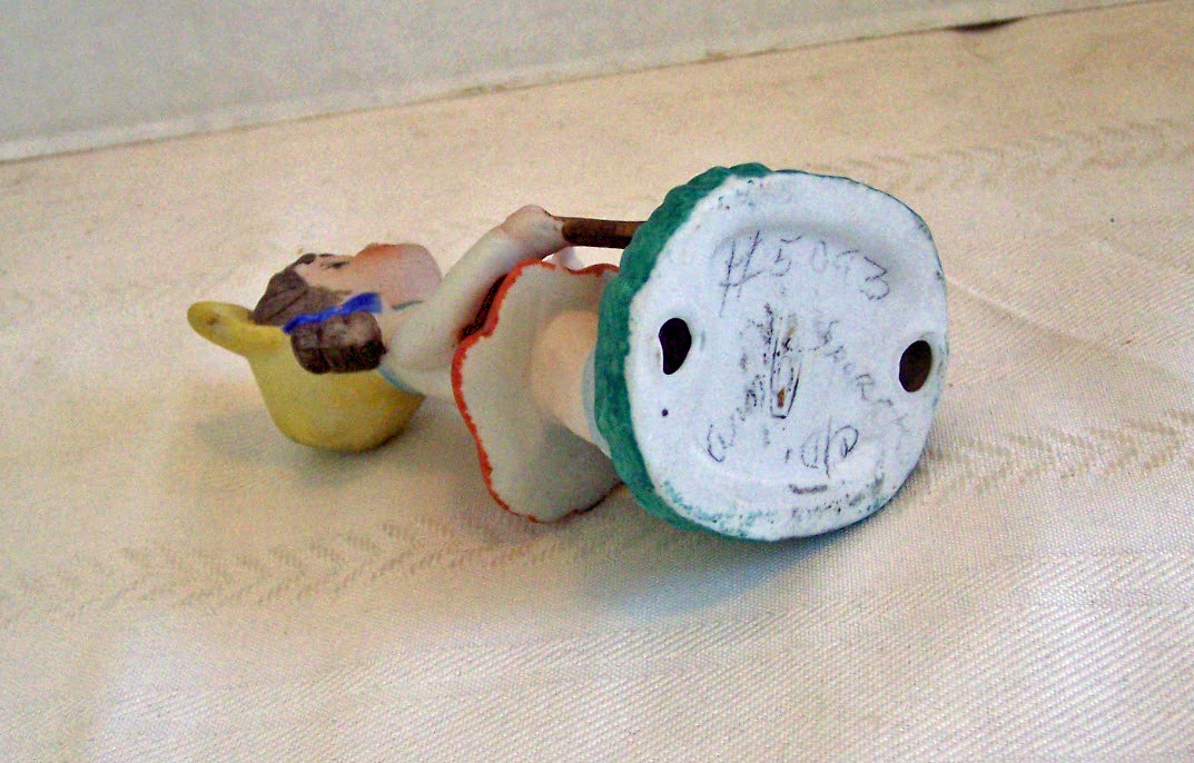 Bisque Girl Figurine Getting Ready to Play Golf