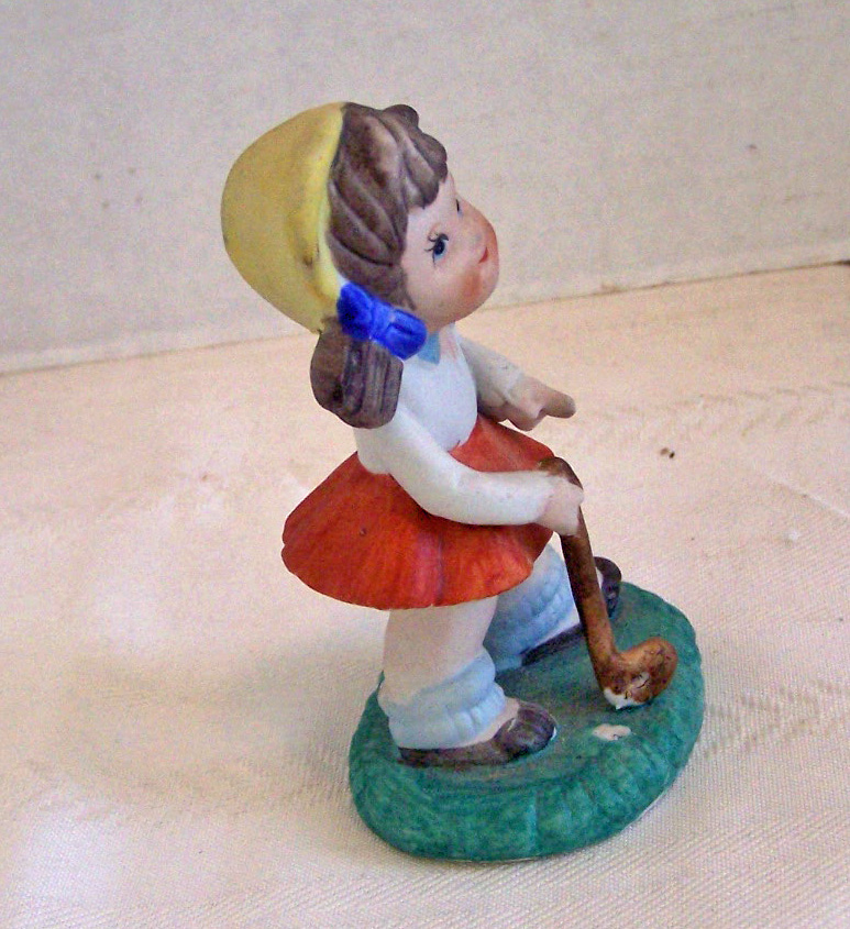 Bisque Girl Figurine Getting Ready to Play Golf