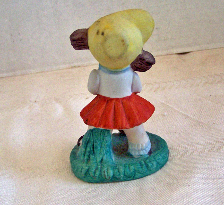 Bisque Girl Figurine Getting Ready to Play Golf
