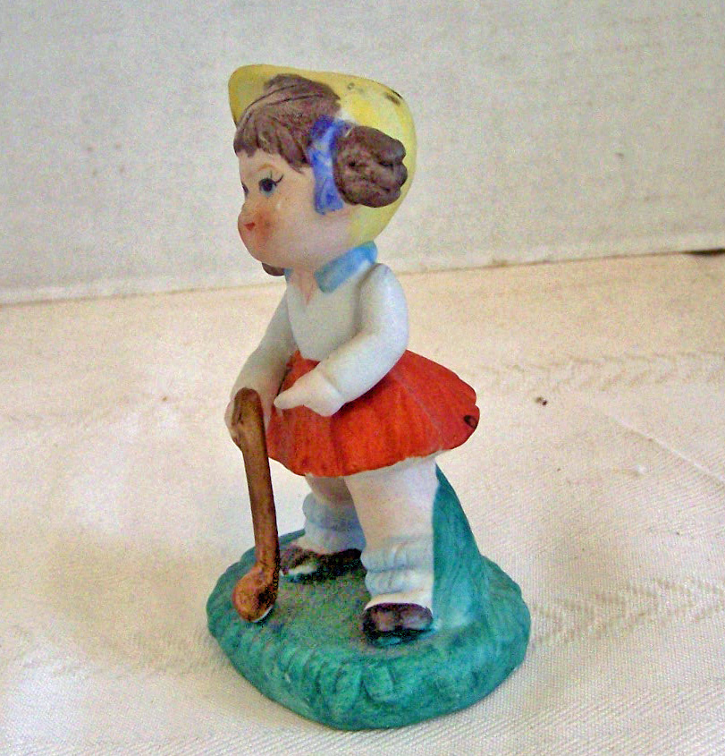 Bisque Girl Figurine Getting Ready to Play Golf