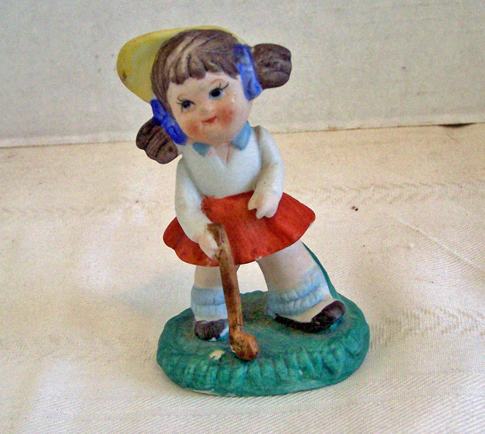 Bisque Girl Figurine Getting Ready to Play Golf