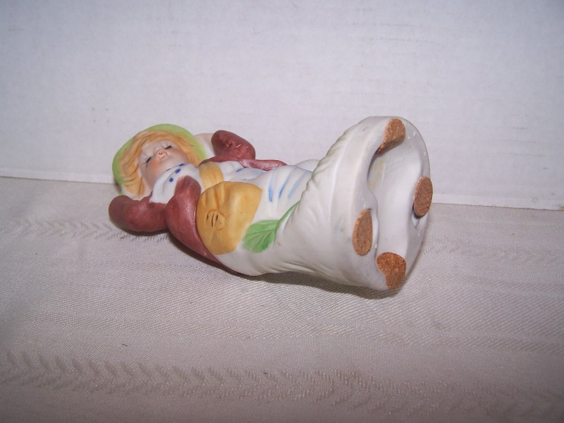 Bisque Boy Figurine Holding His Hat on a Windy Day