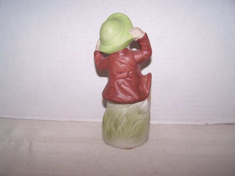 Bisque Boy Figurine Holding His Hat on a Windy Day