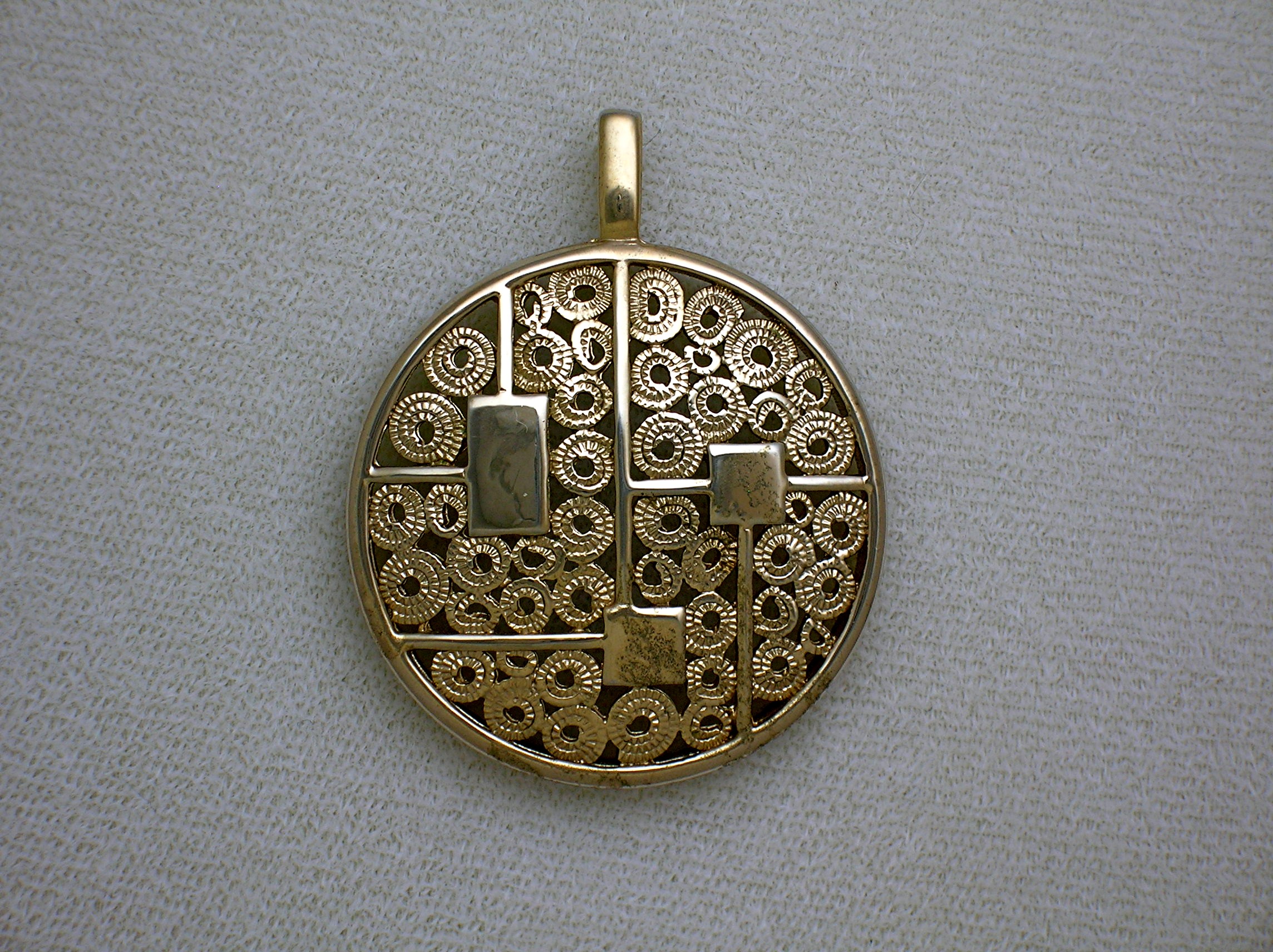 Sarah Coventry Goldtone Round Heavy Filigree Pendant  .