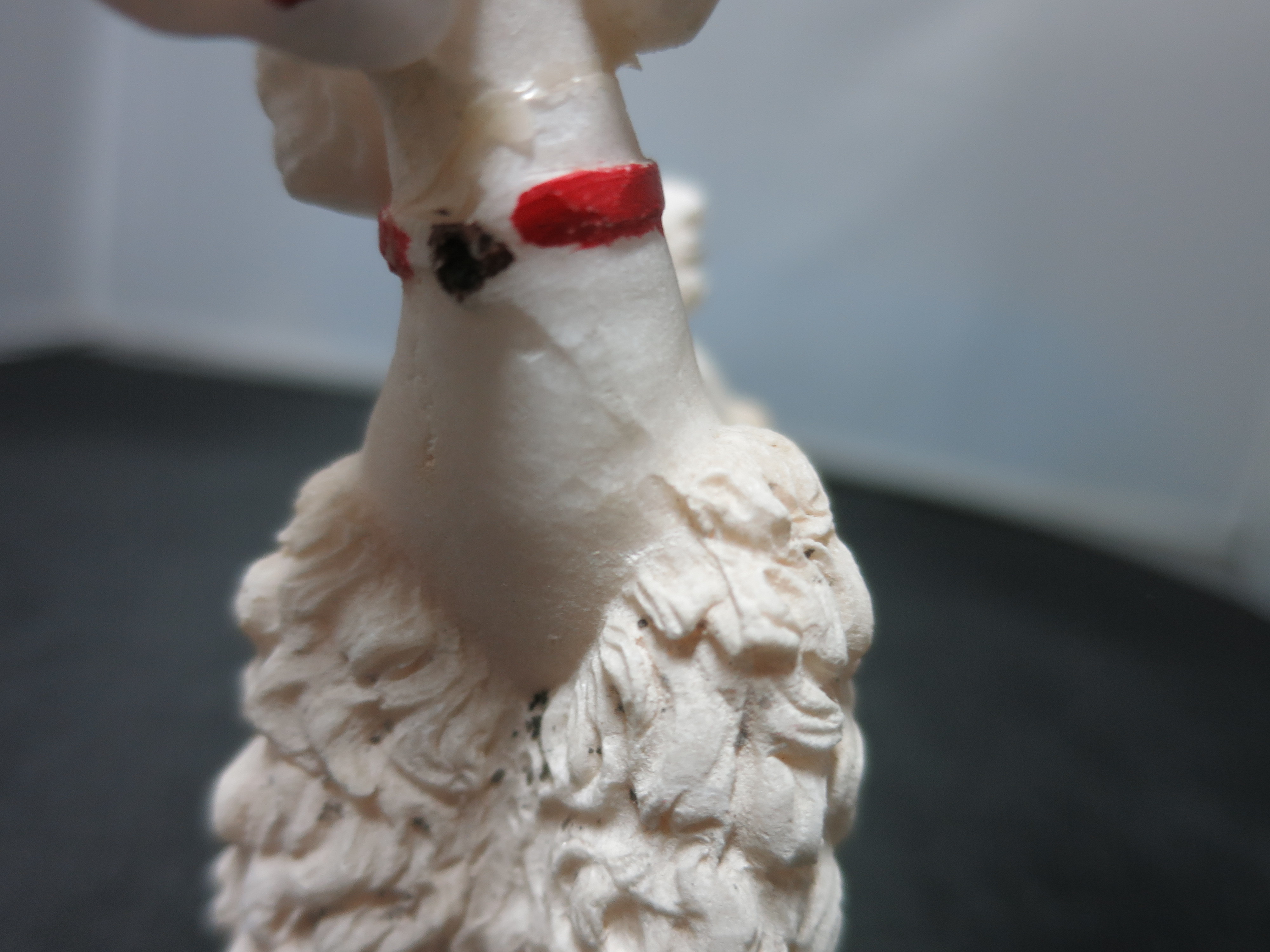 Spaghetti Poodle standing red collar broken and glued on neck