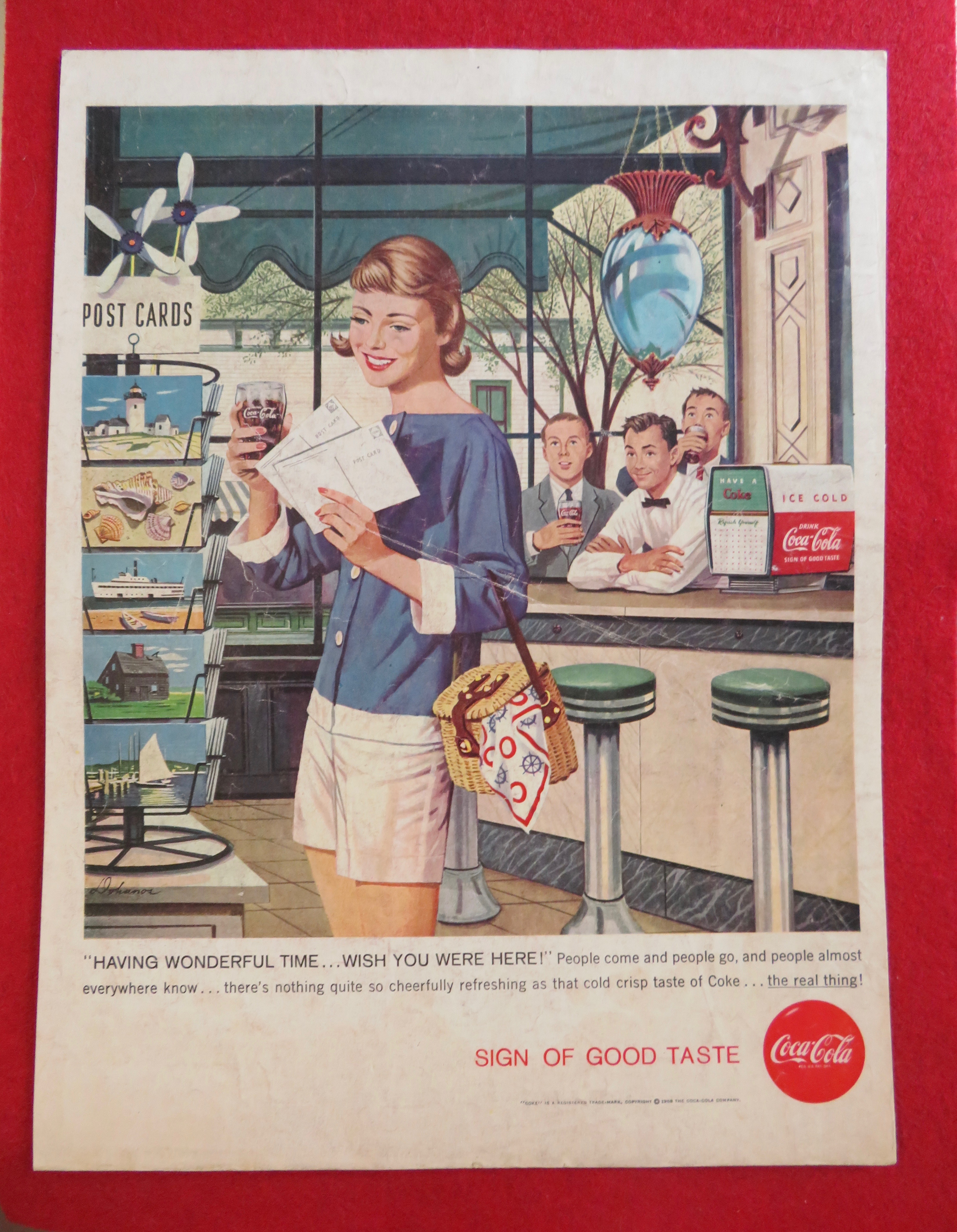 1958 Coca Cola (Coke) with Girl Looking at Postcards
