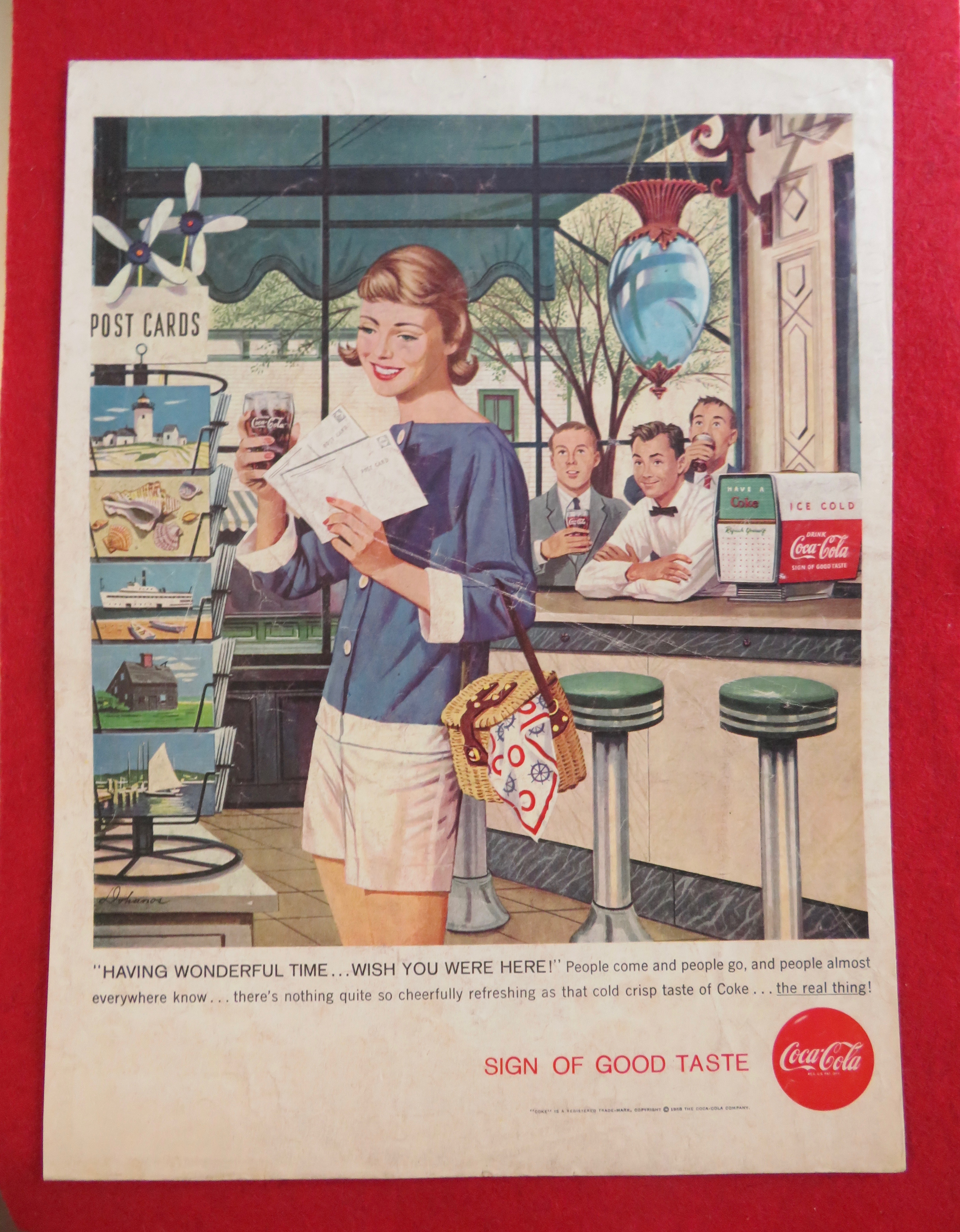 1958 Coca Cola (Coke) with Girl Looking at Postcards