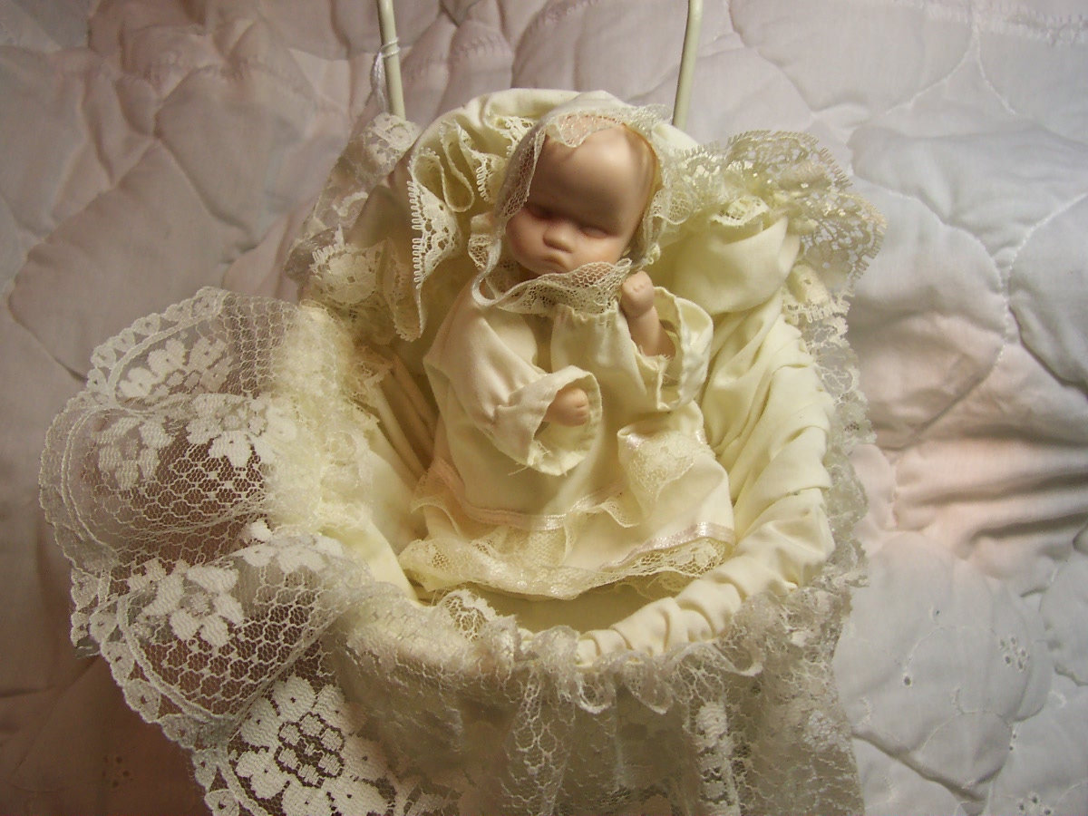 Porcelain Baby Doll in Wicker Carriage