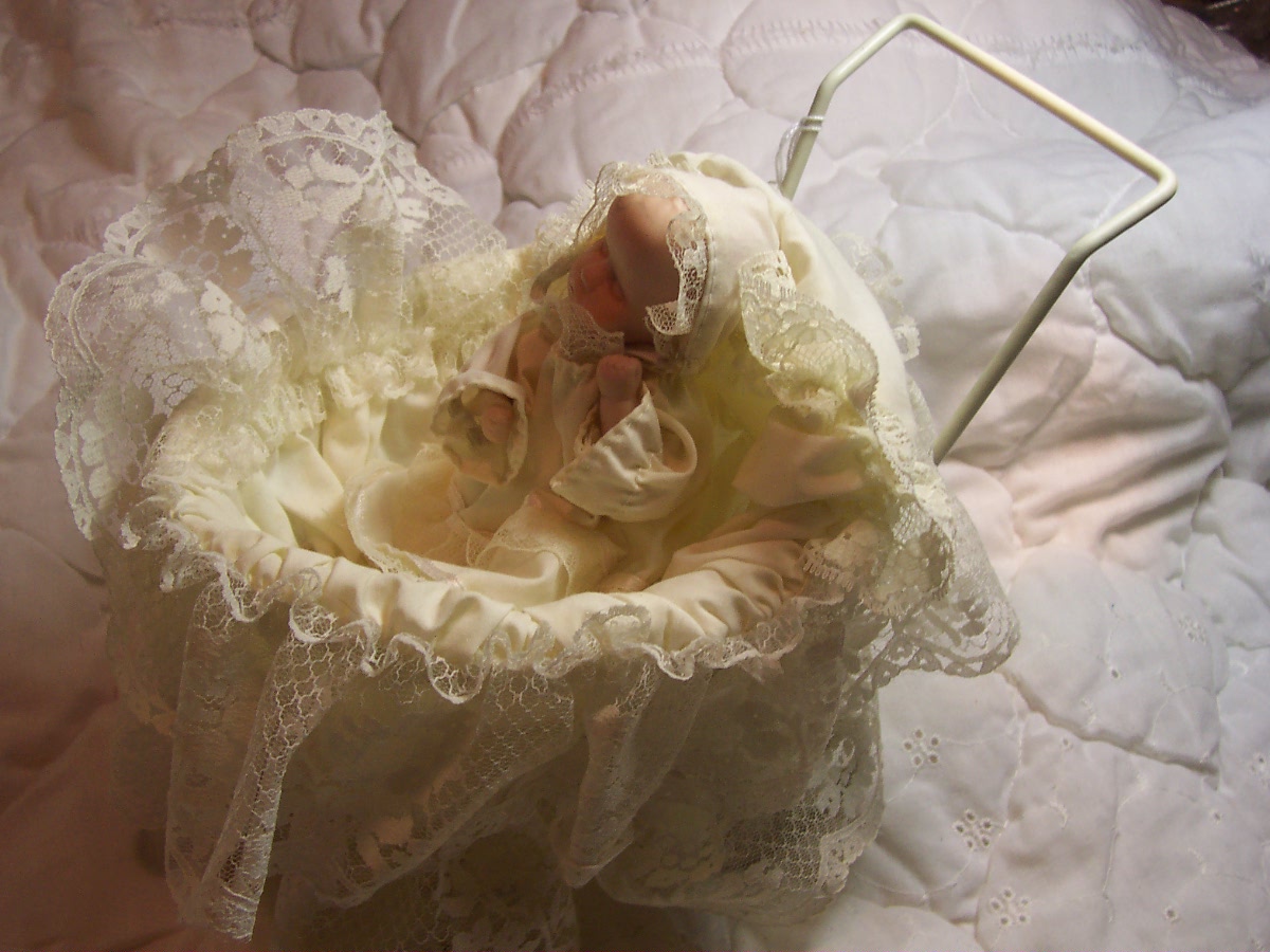 Porcelain Baby Doll in Wicker Carriage