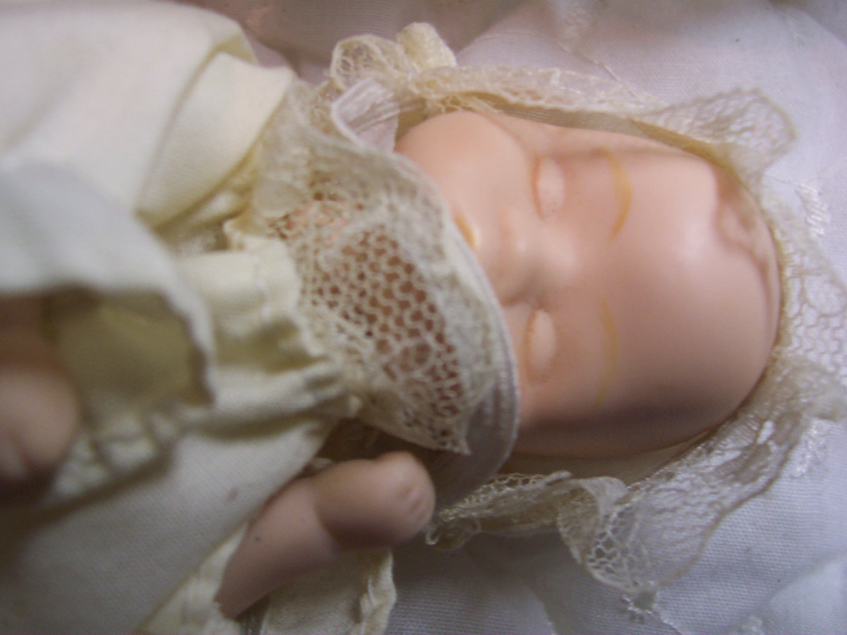 Porcelain Baby Doll in Wicker Carriage