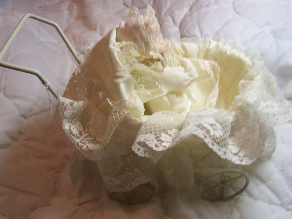 Porcelain Baby Doll in Wicker Carriage