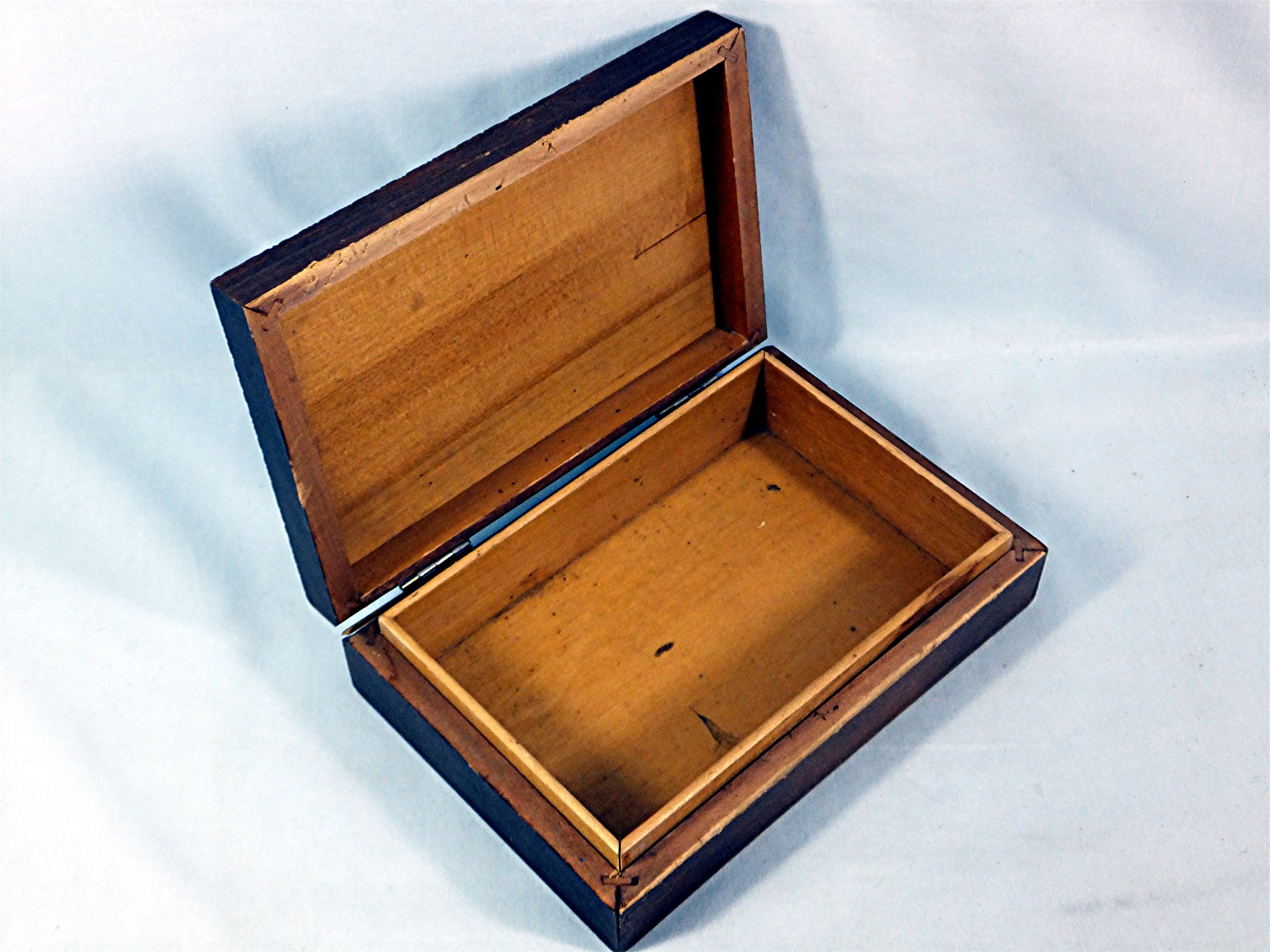Carved wooden box hinged with brass inlay