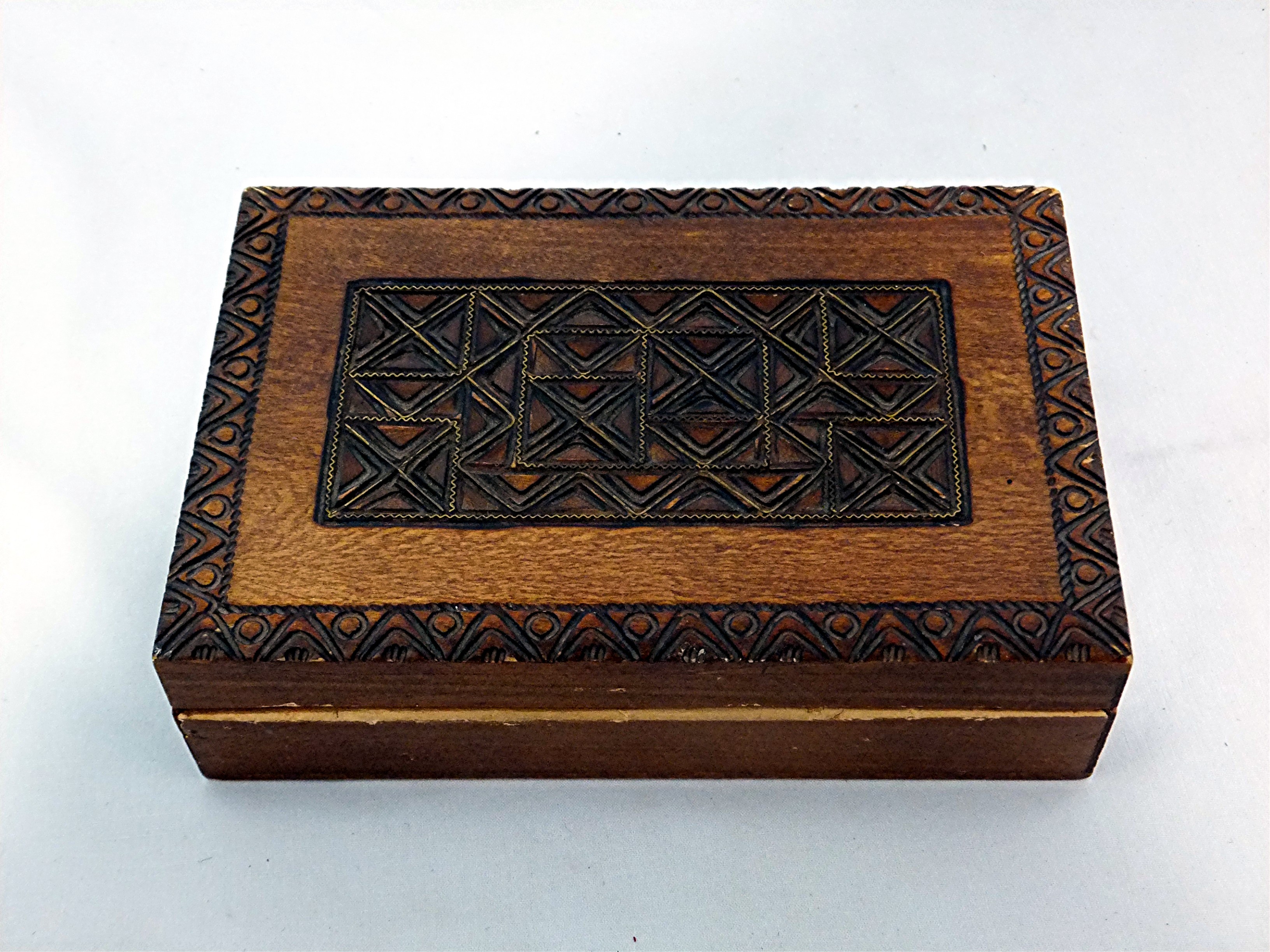 Carved wooden box hinged with brass inlay