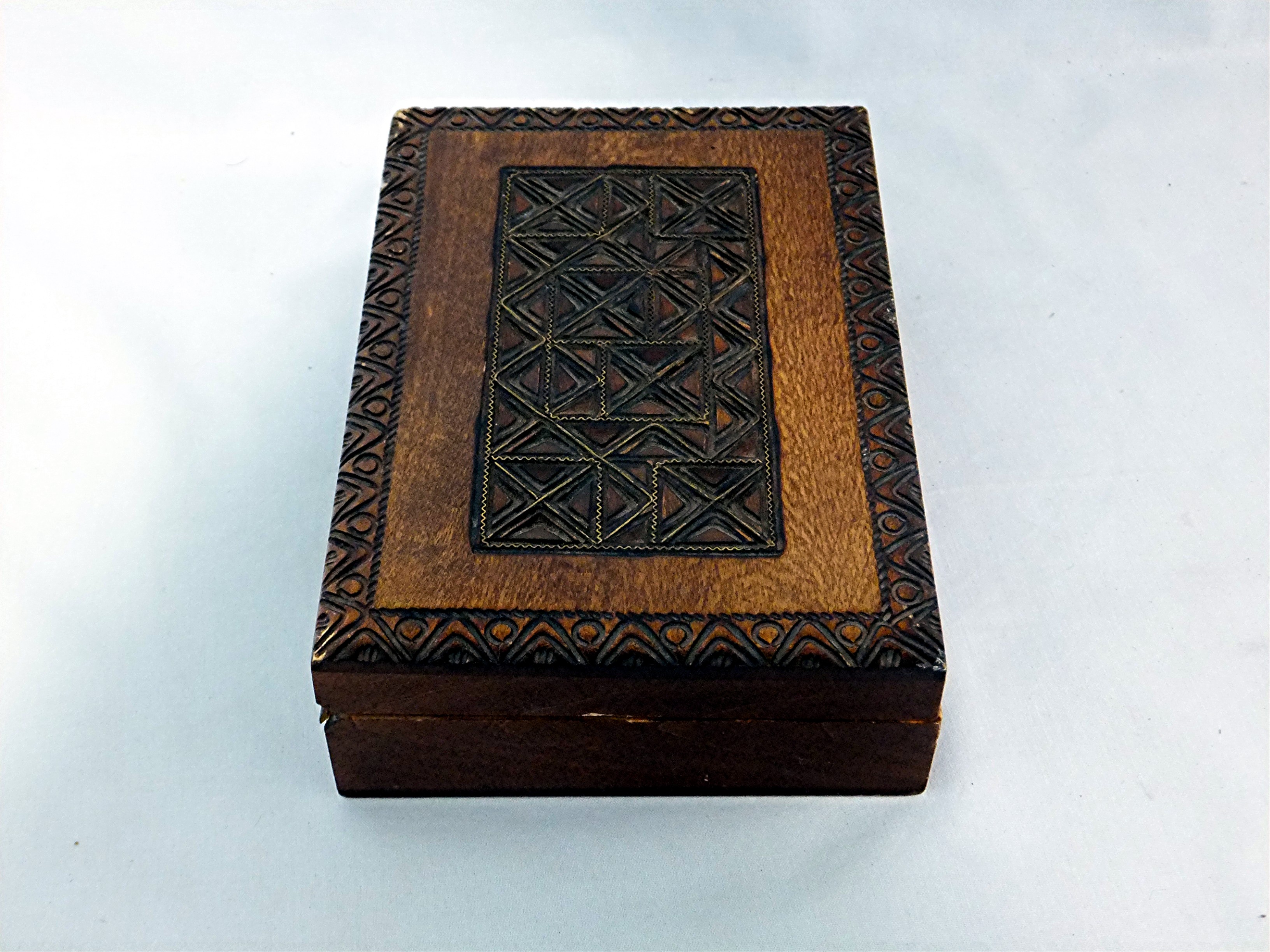 Carved wooden box hinged with brass inlay