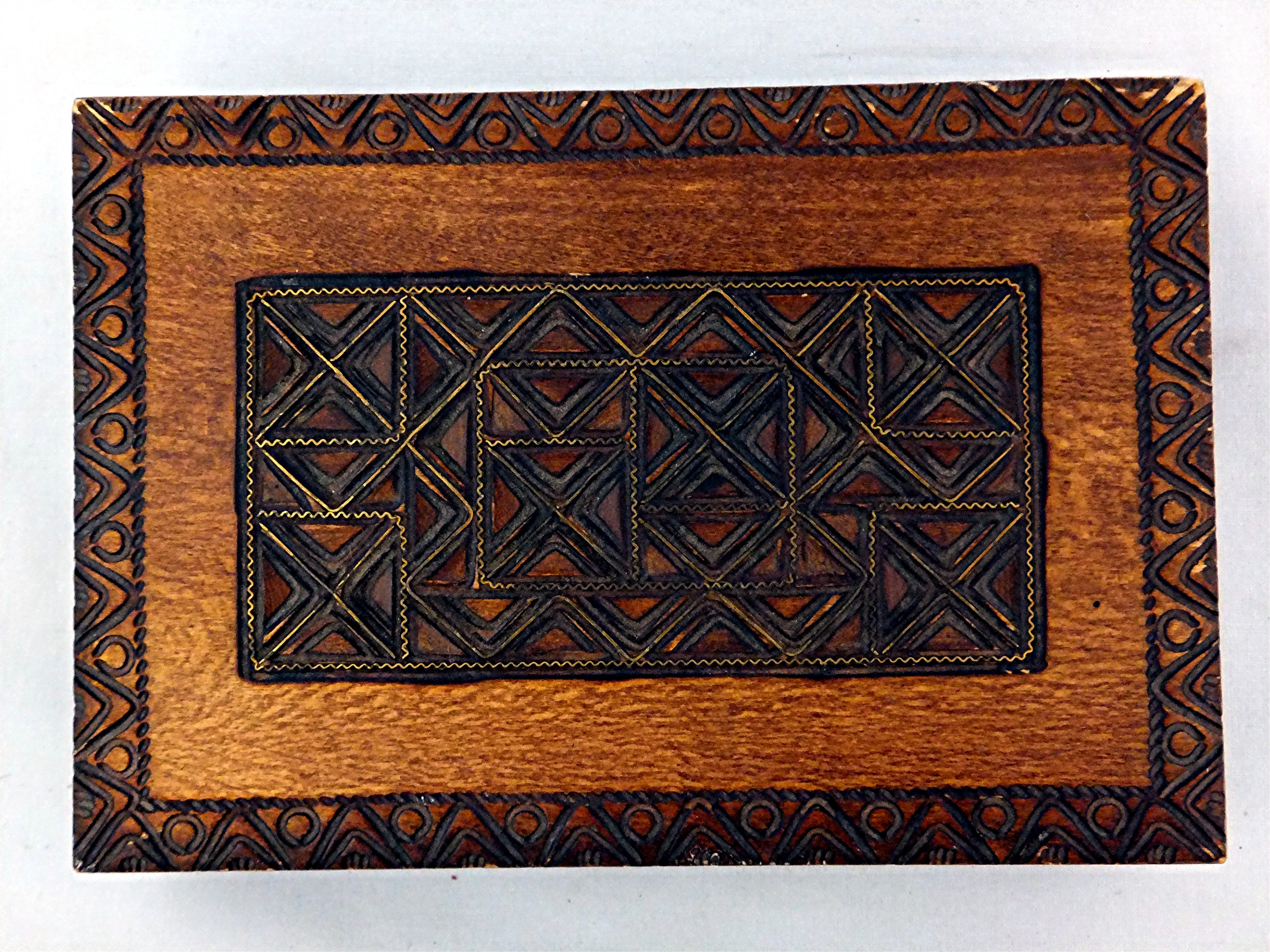 Carved wooden box hinged with brass inlay