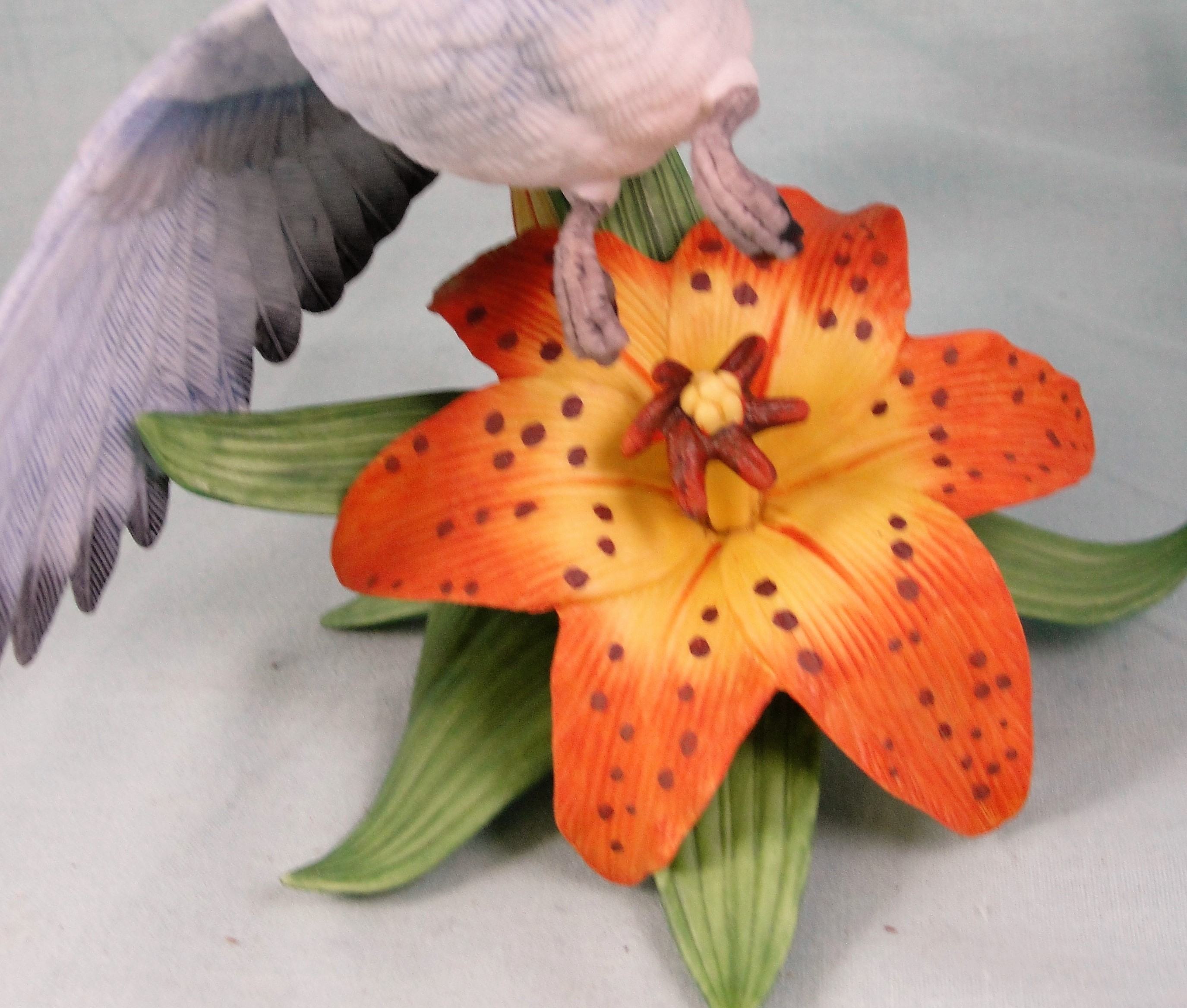 Lenox Mountain Bluebird in Flight Over a Lily