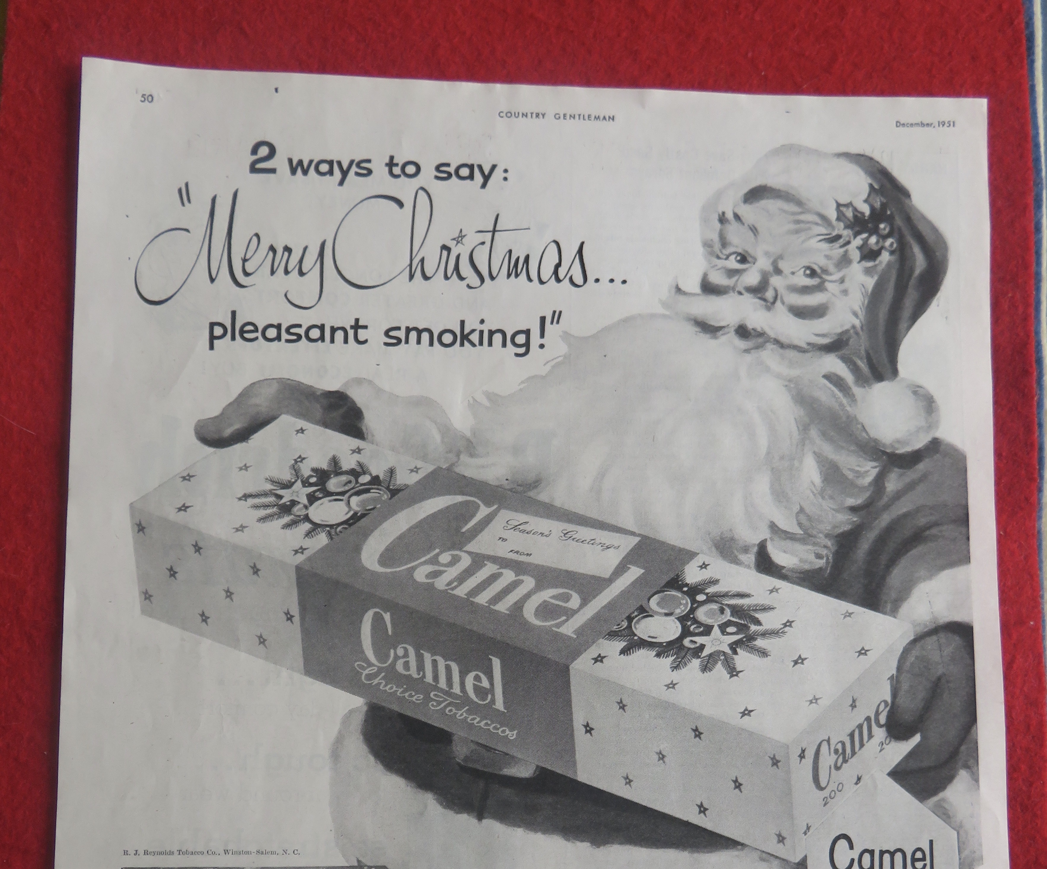1951 Camel Cigarettes with Santa Claus Holding A Carton