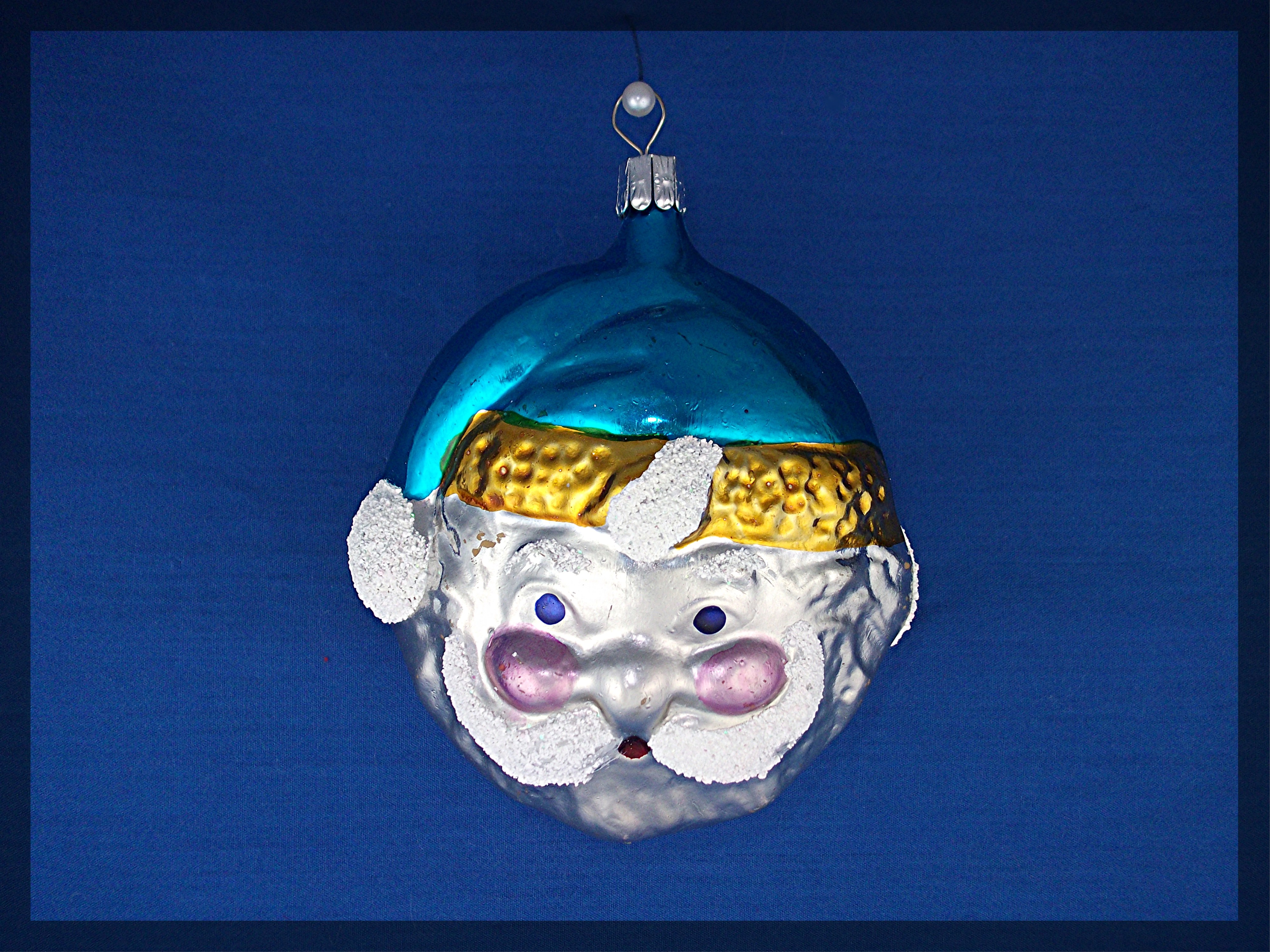 Santa face Christmas tree ornament with blue cap . .