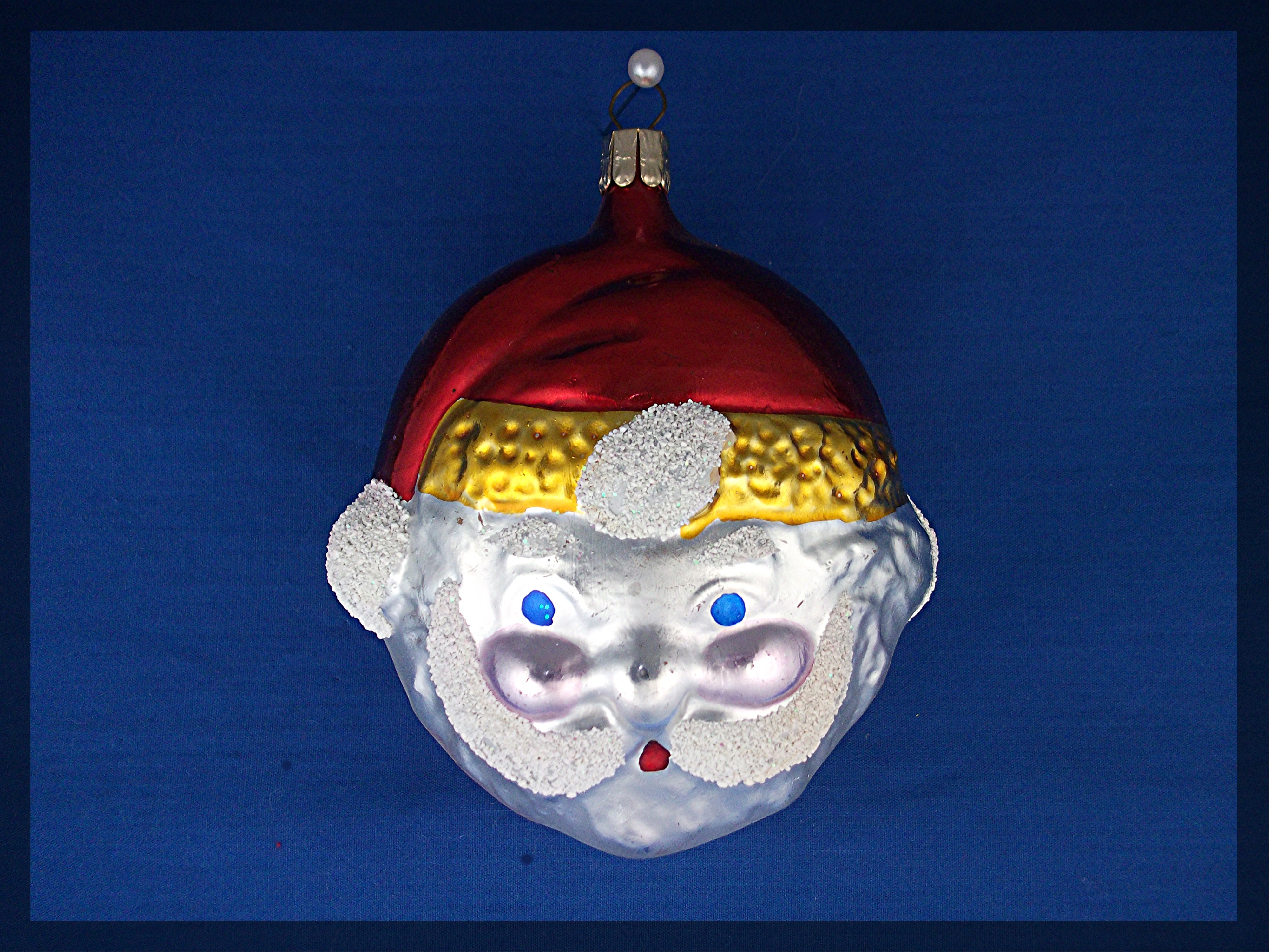 Santa face Christmas tree ornament with red cap . .