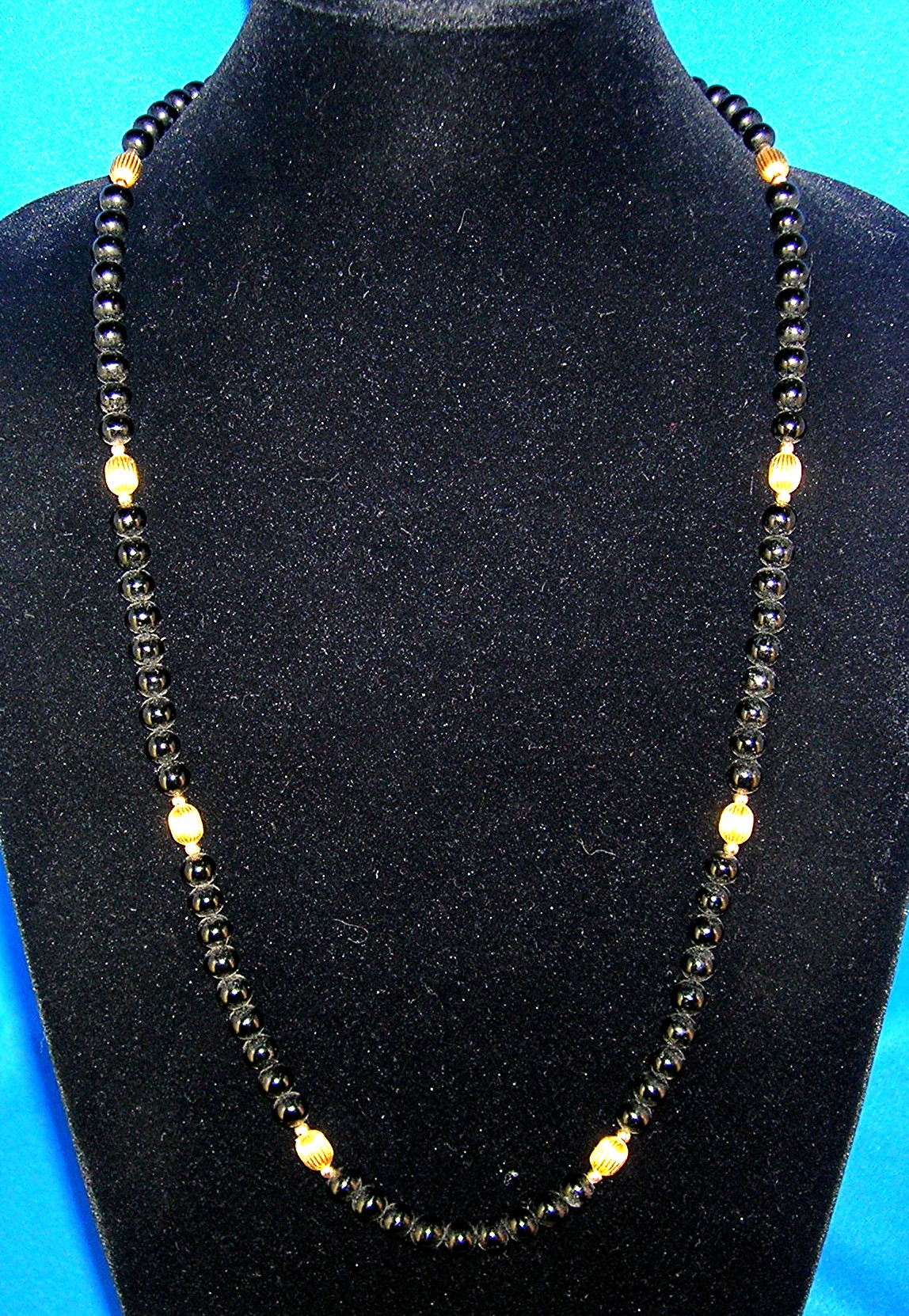 28 Inch Necklace of 7mm Black Onyx/Gold Beads