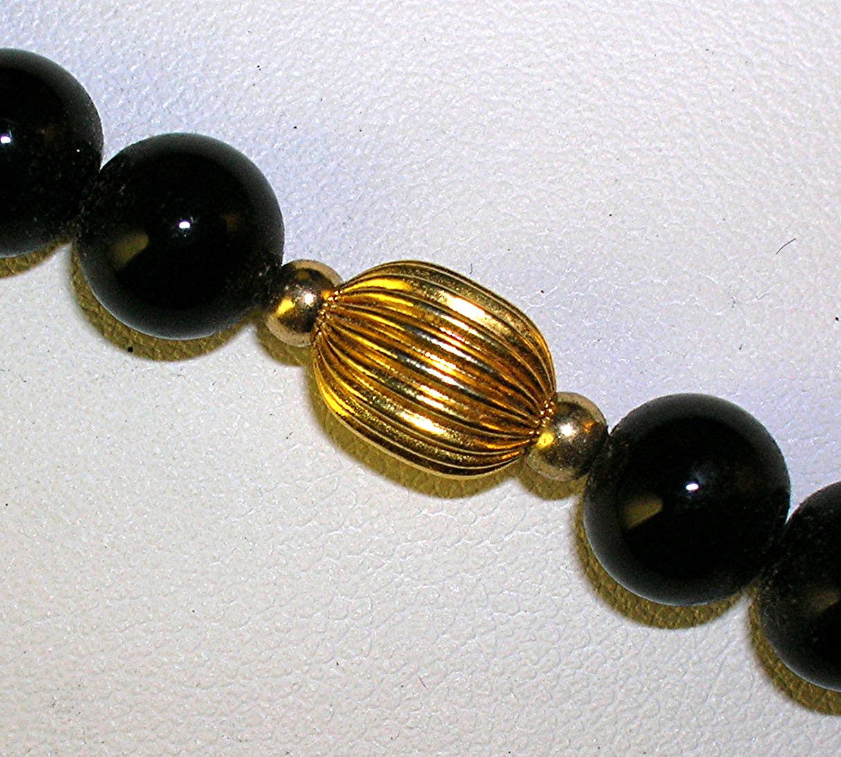 28 Inch Necklace of 7mm Black Onyx/Gold Beads