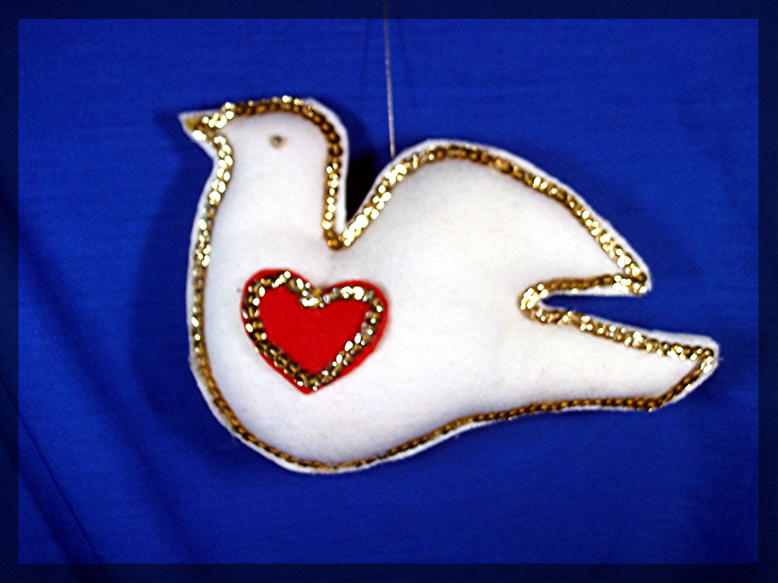 Handmade white dove decoration with red heart