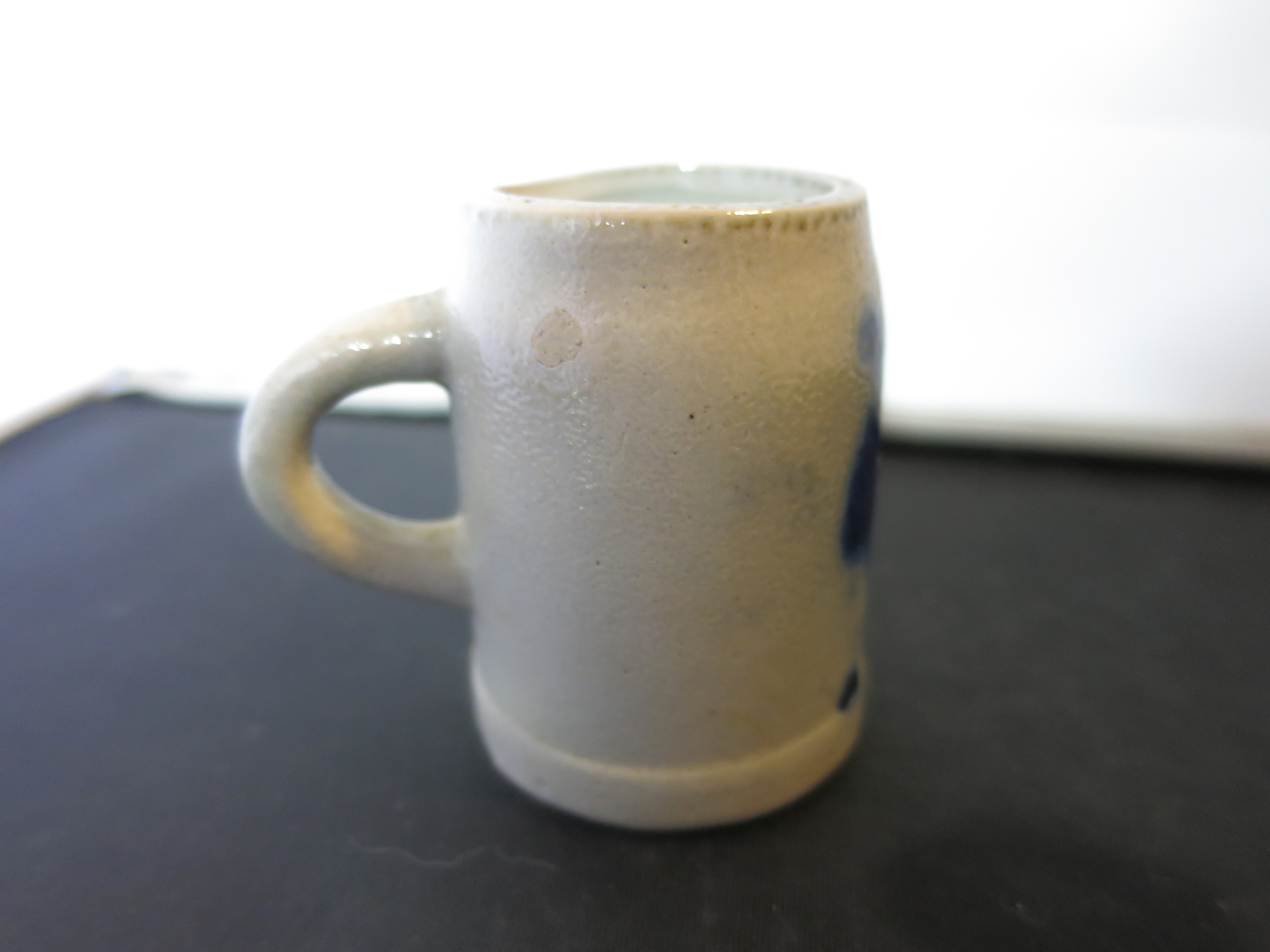 Stoneware Shot Stein with a flow blue motif Height 2 1/8 inches