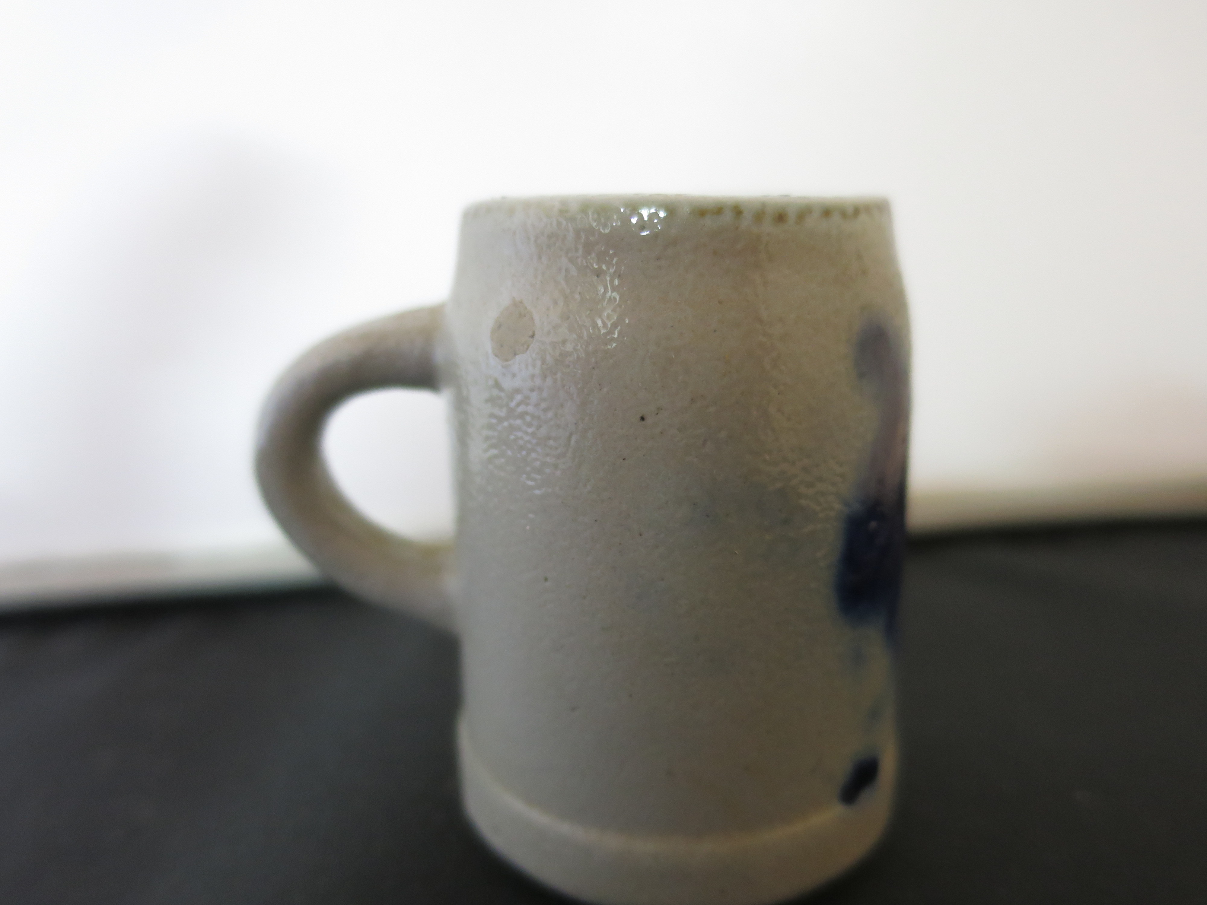 Stoneware Shot Stein with a flow blue motif Height 2 1/8 inches