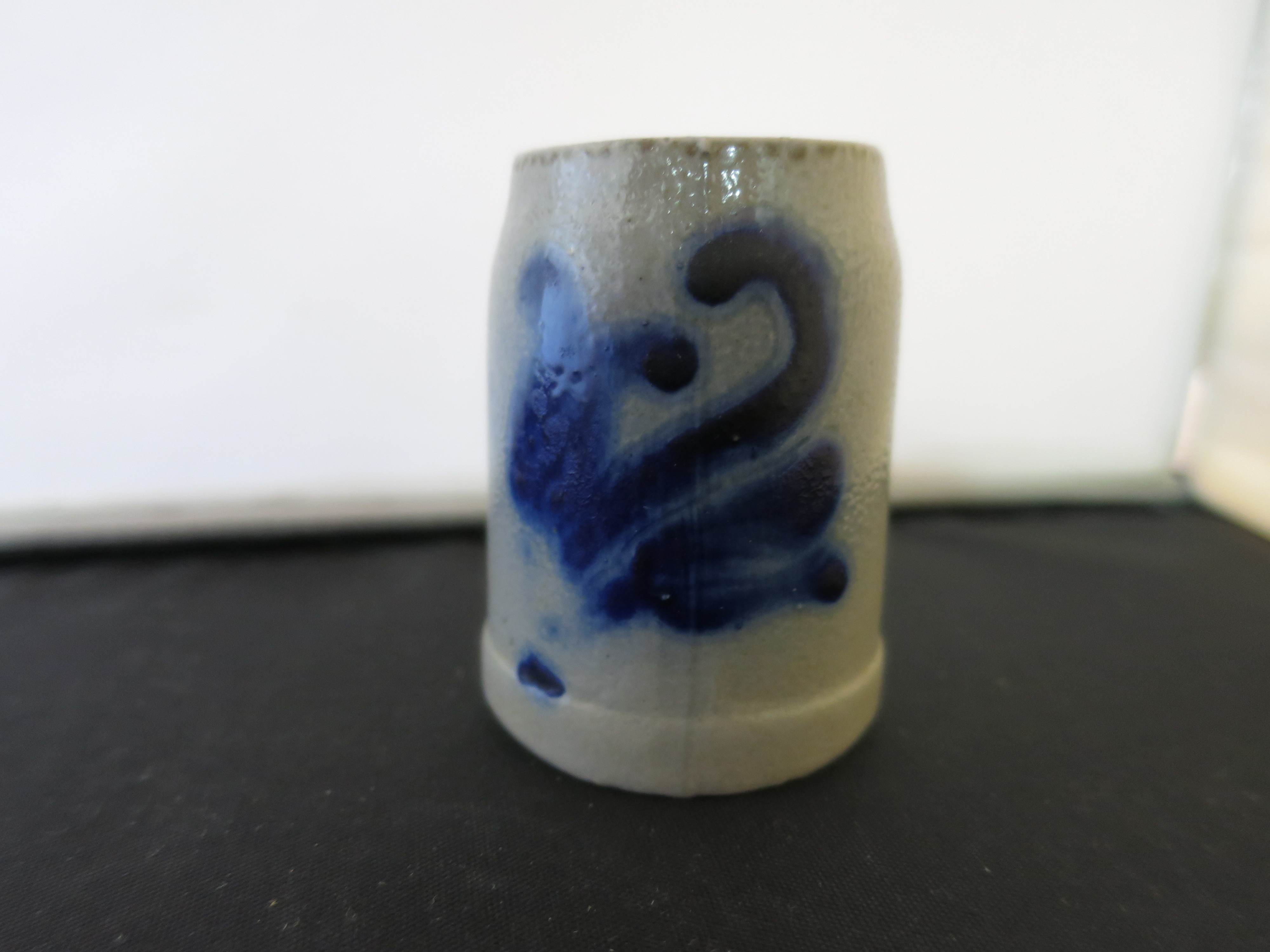 Stoneware Shot Stein with a flow blue motif Height 2 1/8 inches