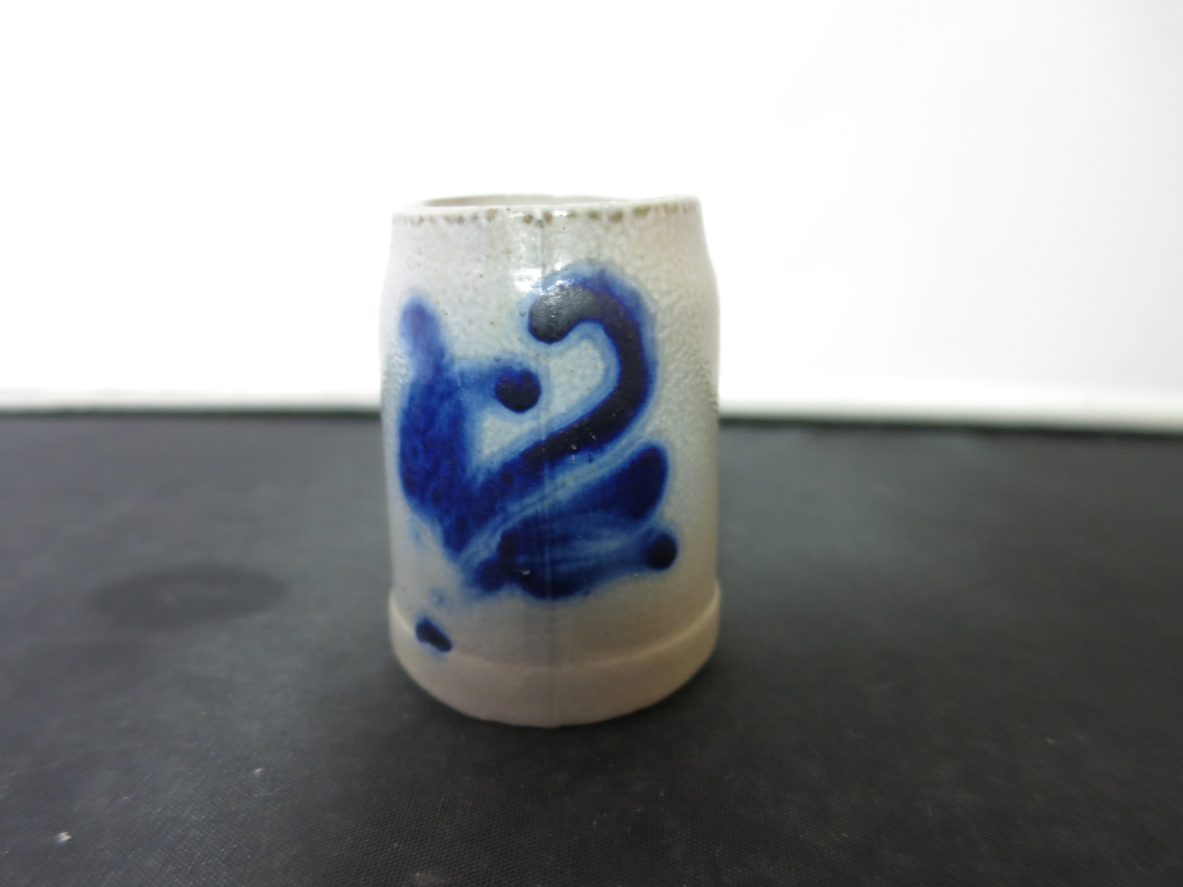 Stoneware Shot Stein with a flow blue motif Height 2 1/8 inches
