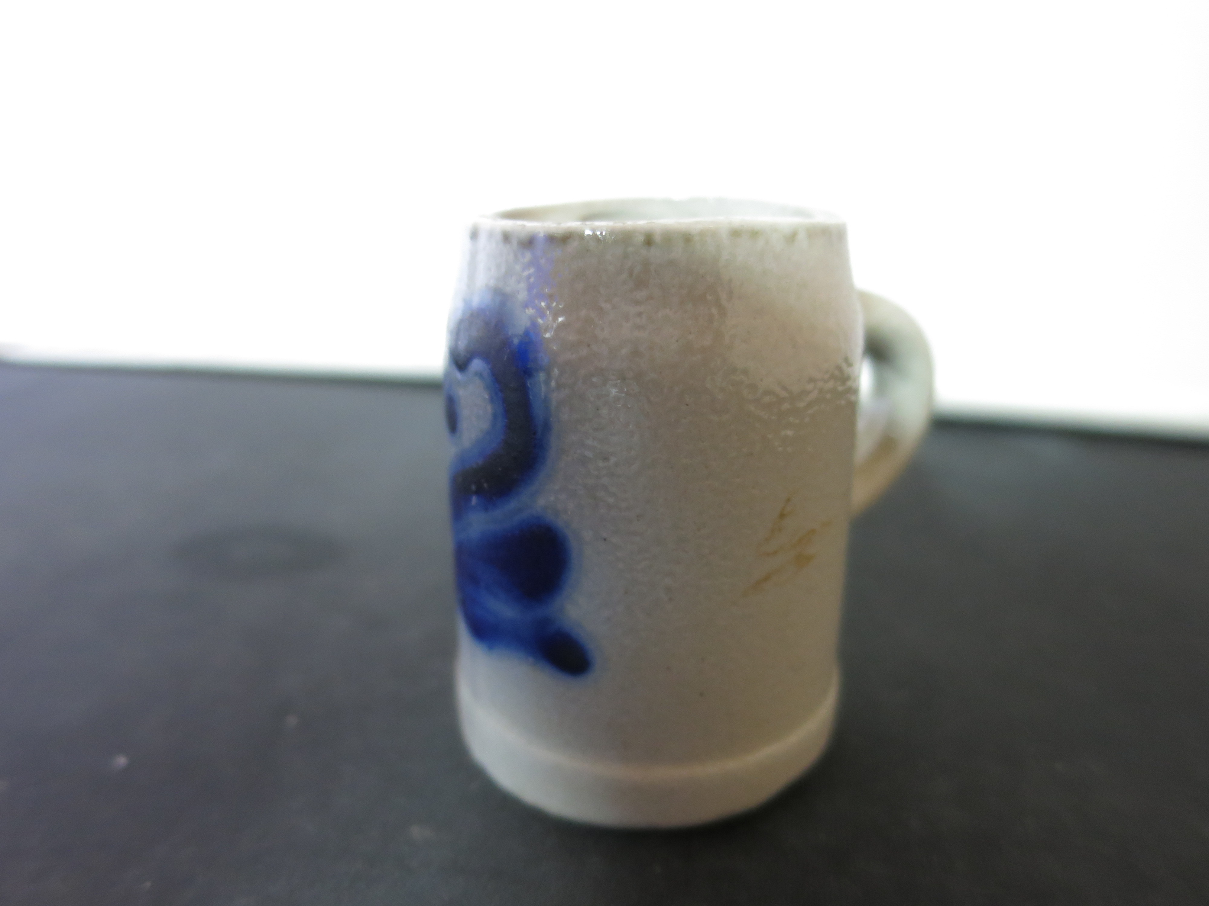 Stoneware Shot Stein with a flow blue motif Height 2 1/8 inches