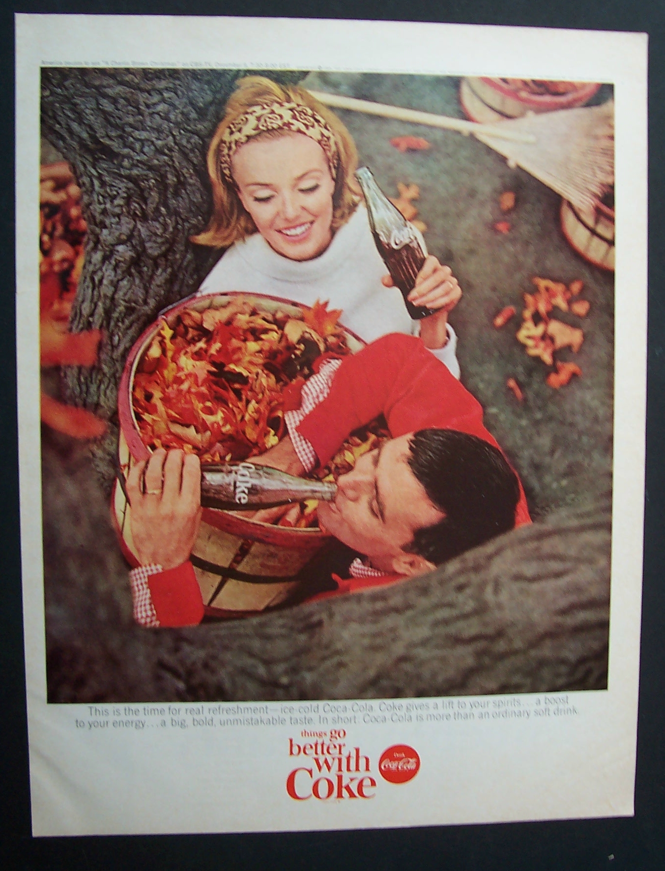 1965 Coca Cola (Coke) w/ Man & Woman Picking Up Leaves
