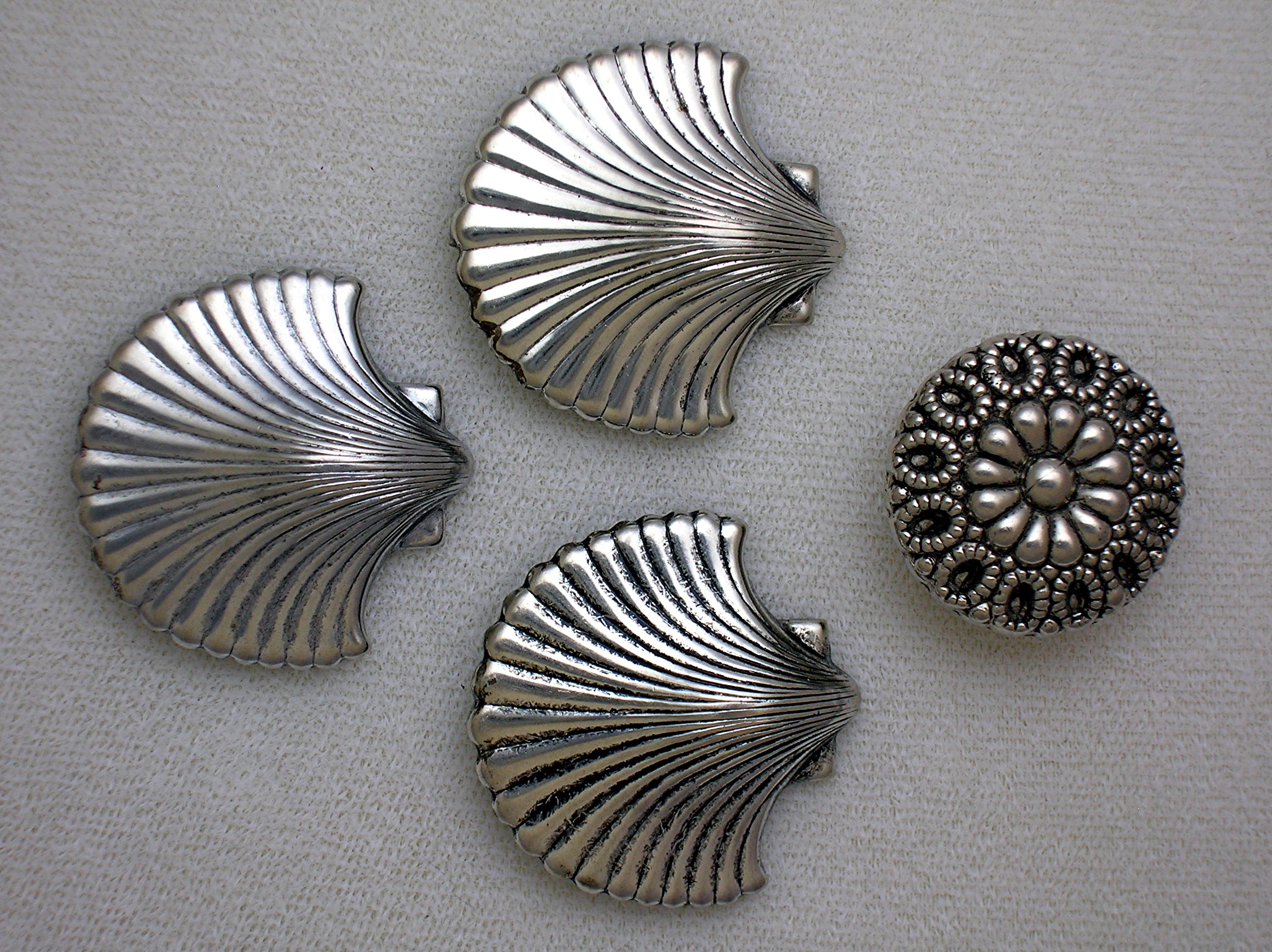 4 Silvertone Shell Button Covers.