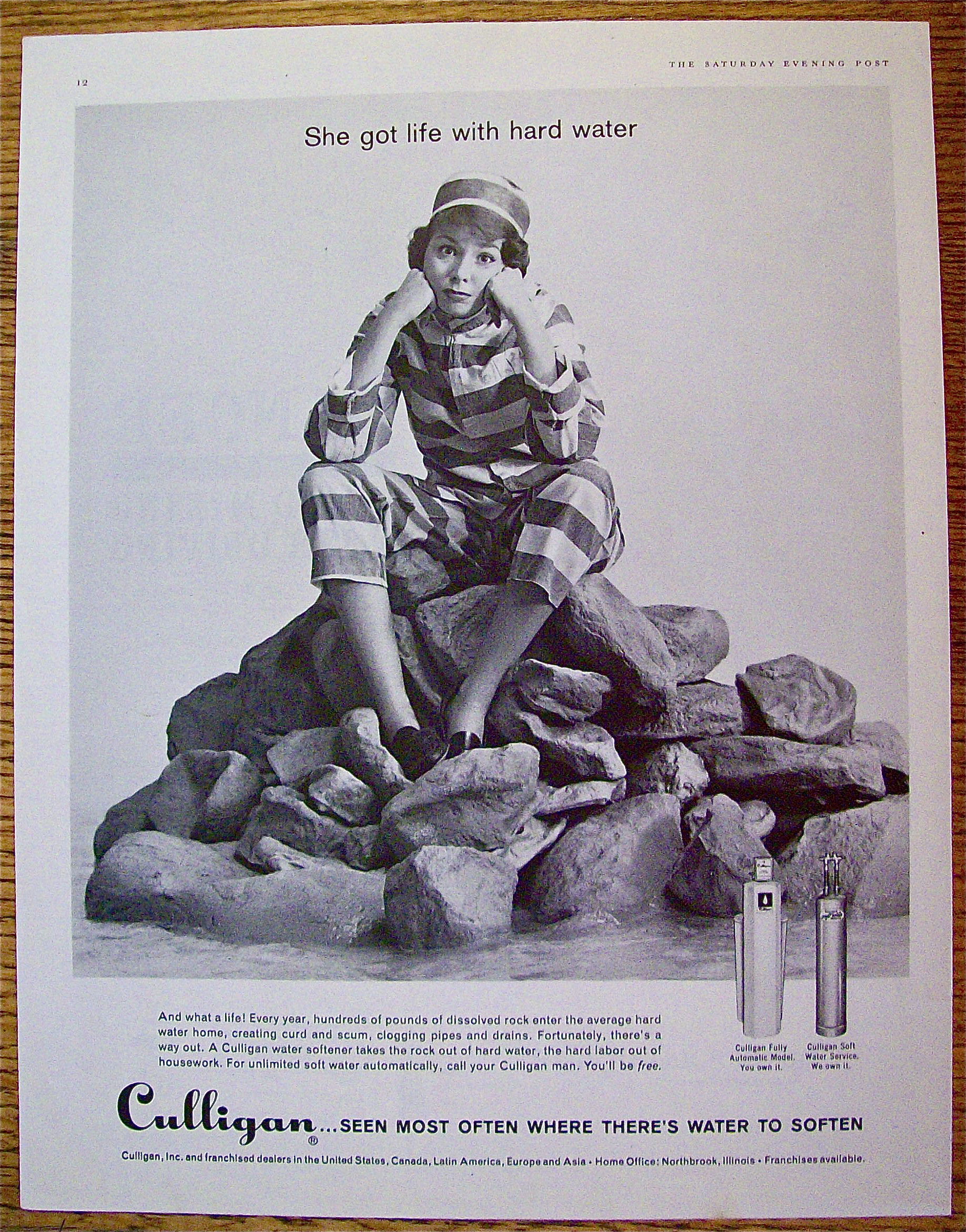 1961 Culligan with woman sitting on rocks.
