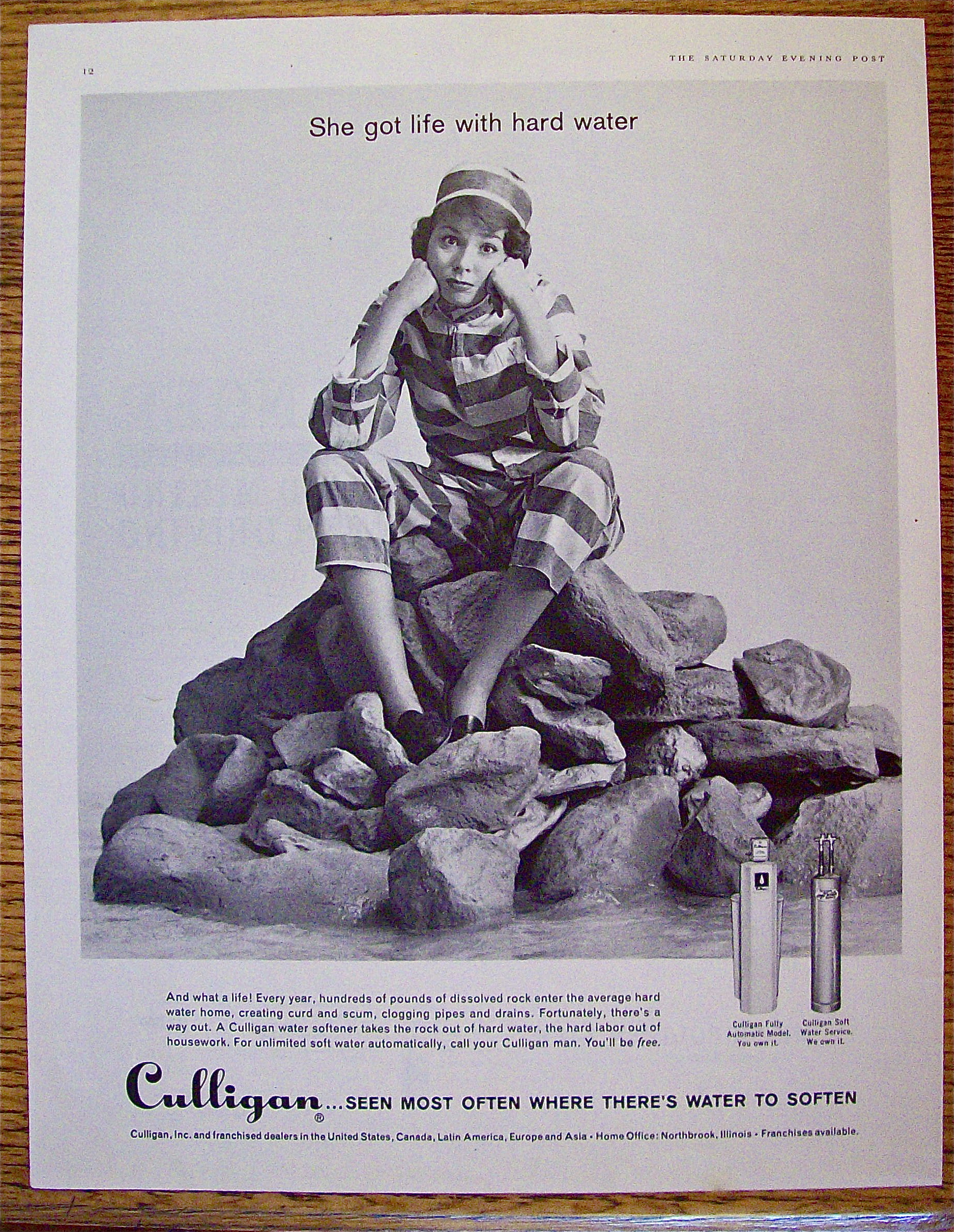 1961 Culligan with woman sitting on rocks.