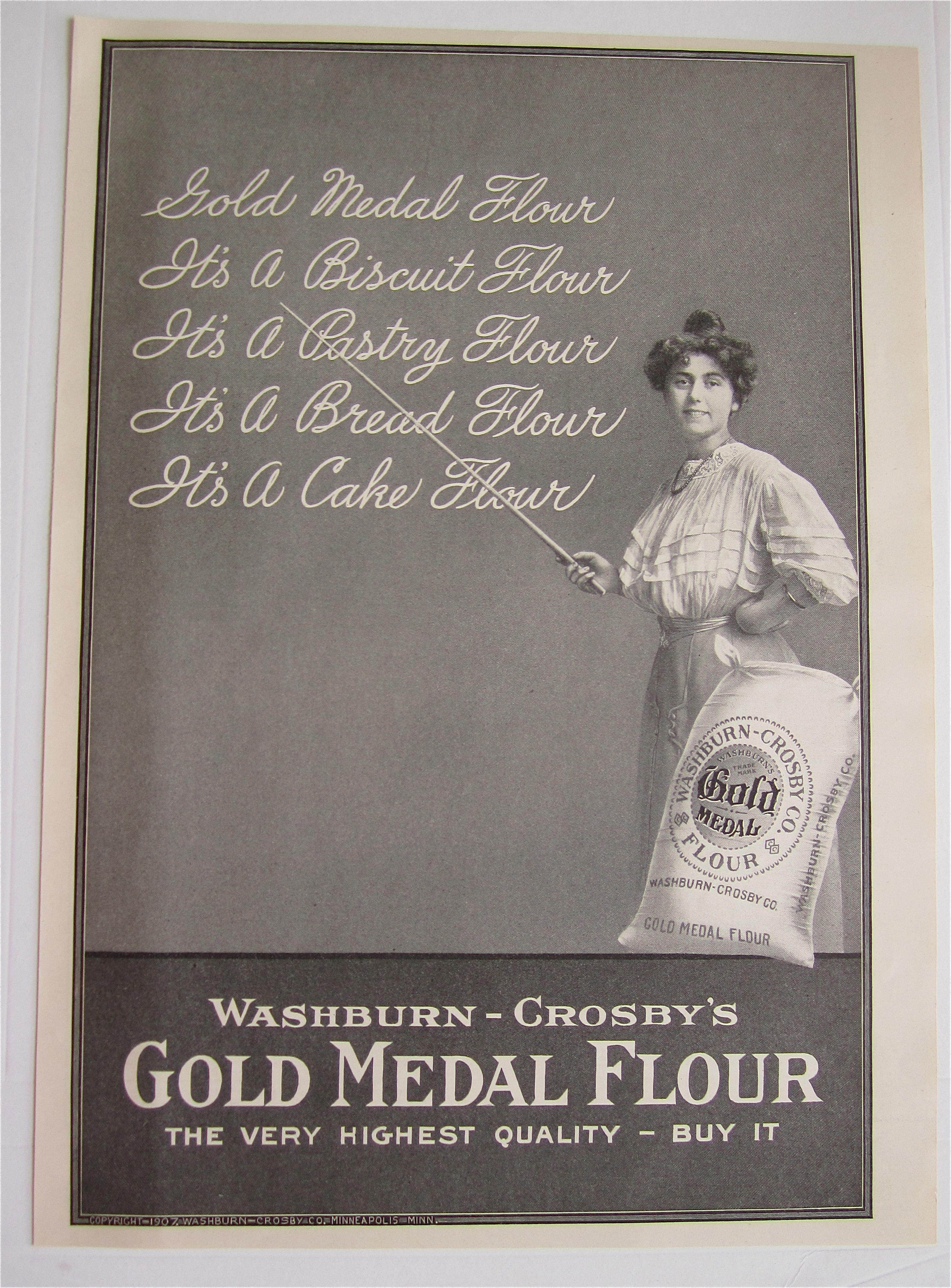 1907 Gold Medal Flour with Woman Pointing To Chalkboard