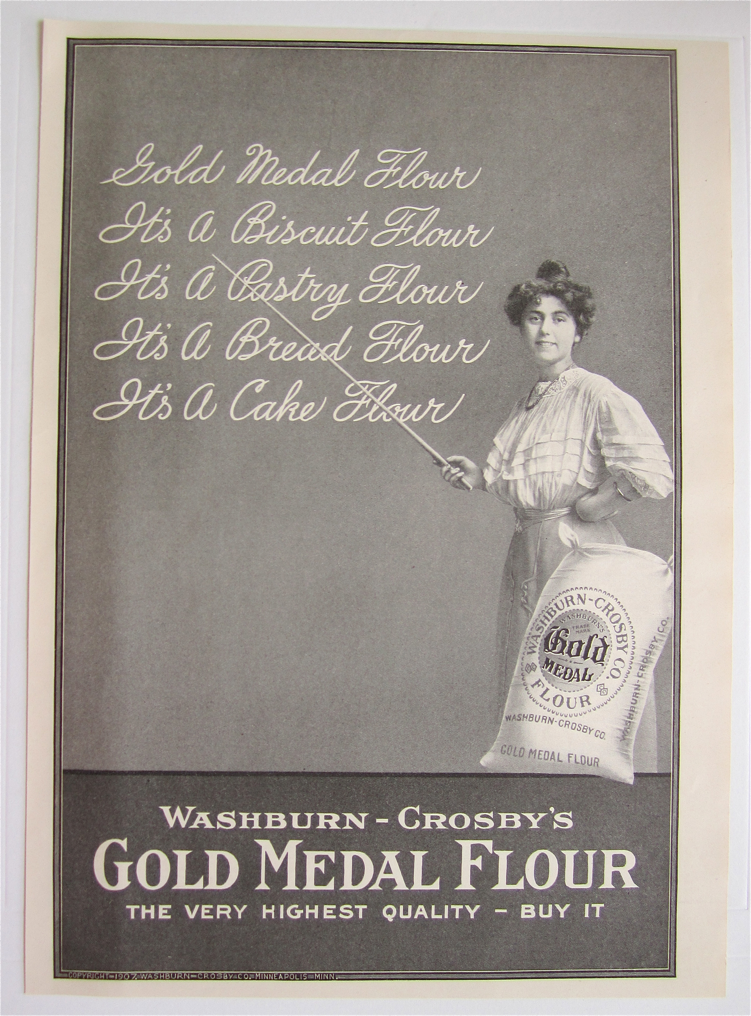 1907 Gold Medal Flour with Woman Pointing To Chalkboard