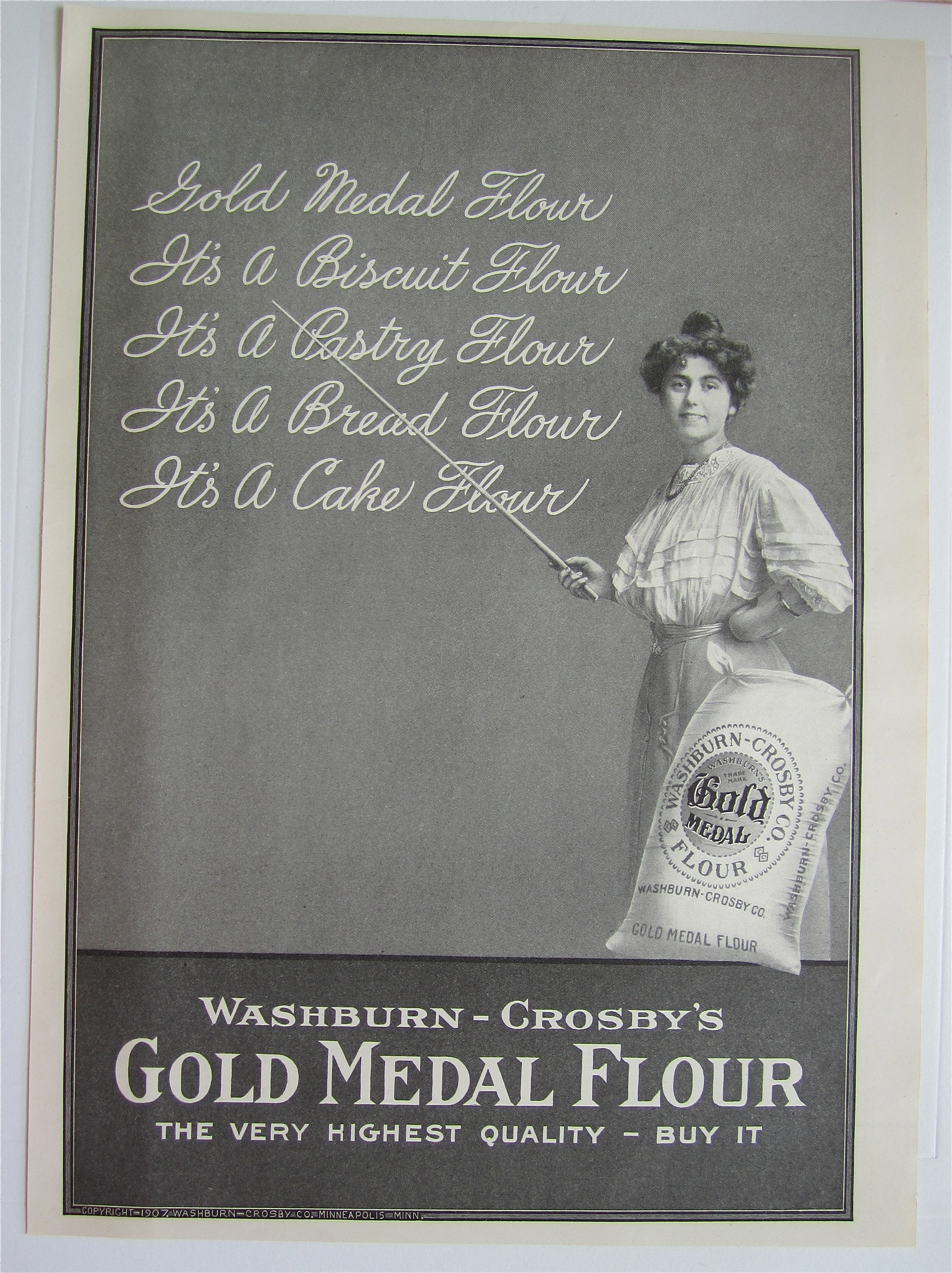 1907 Gold Medal Flour with Woman Pointing To Chalkboard