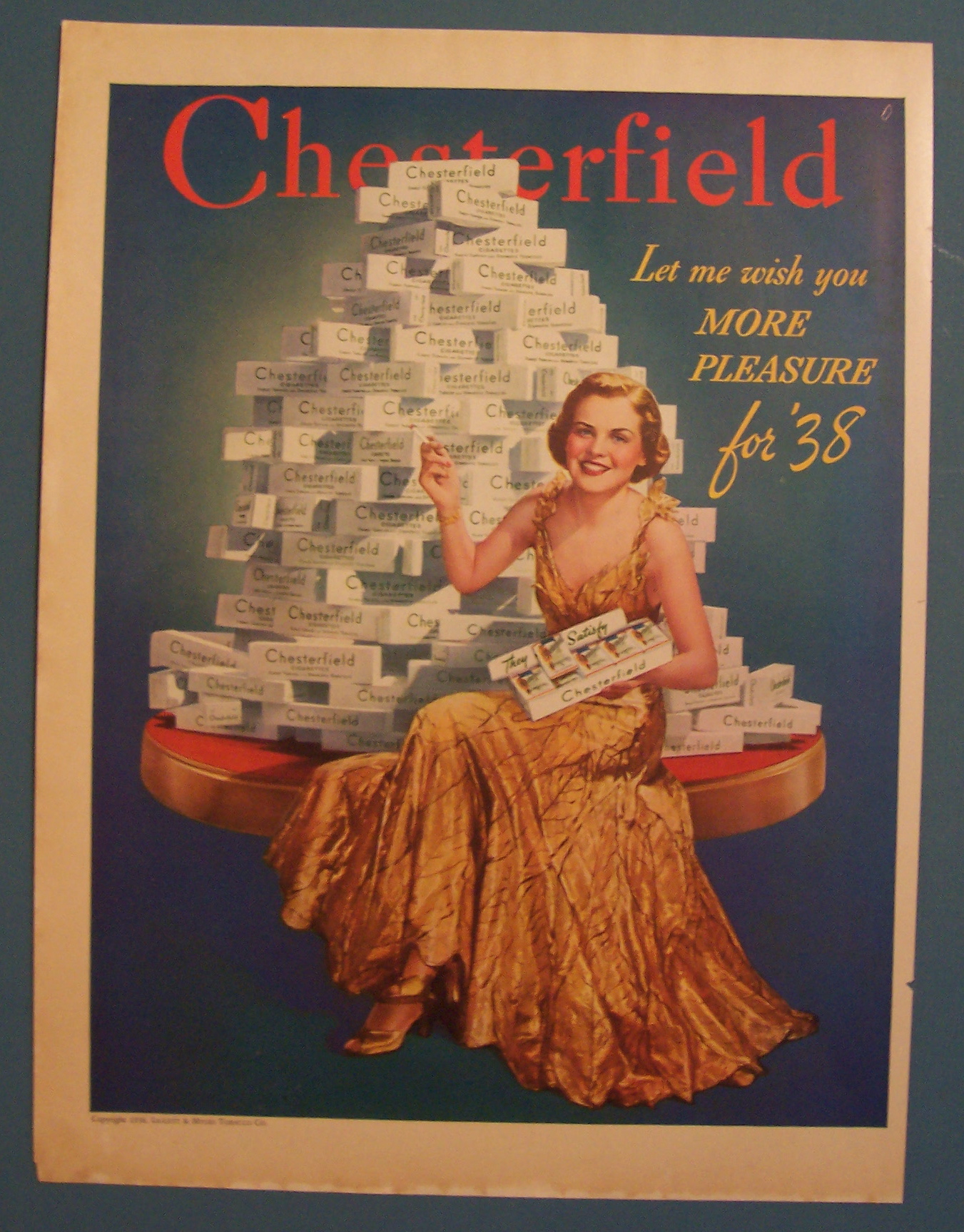 1938 Chesterfield Cigarettes w/Woman Sitting By Stack