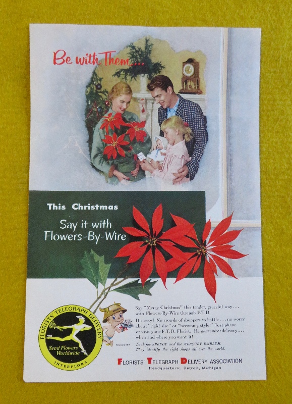 1953 Florists' Telegraph Delivery (FTD) with Woman Holding A Bouquet Of Poinsettias