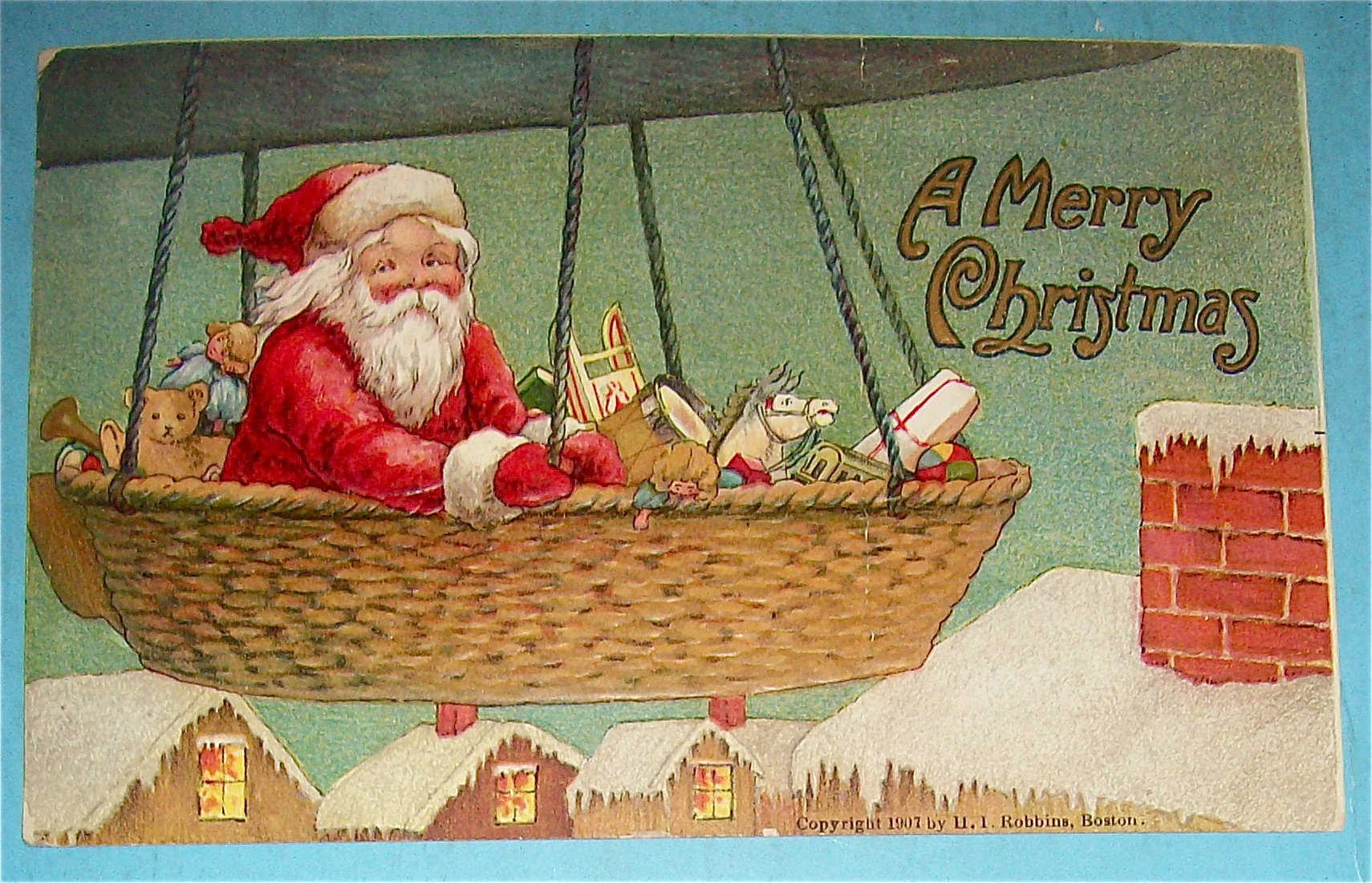 1907 A Merry Christmas Postcard with Santa In Balloon