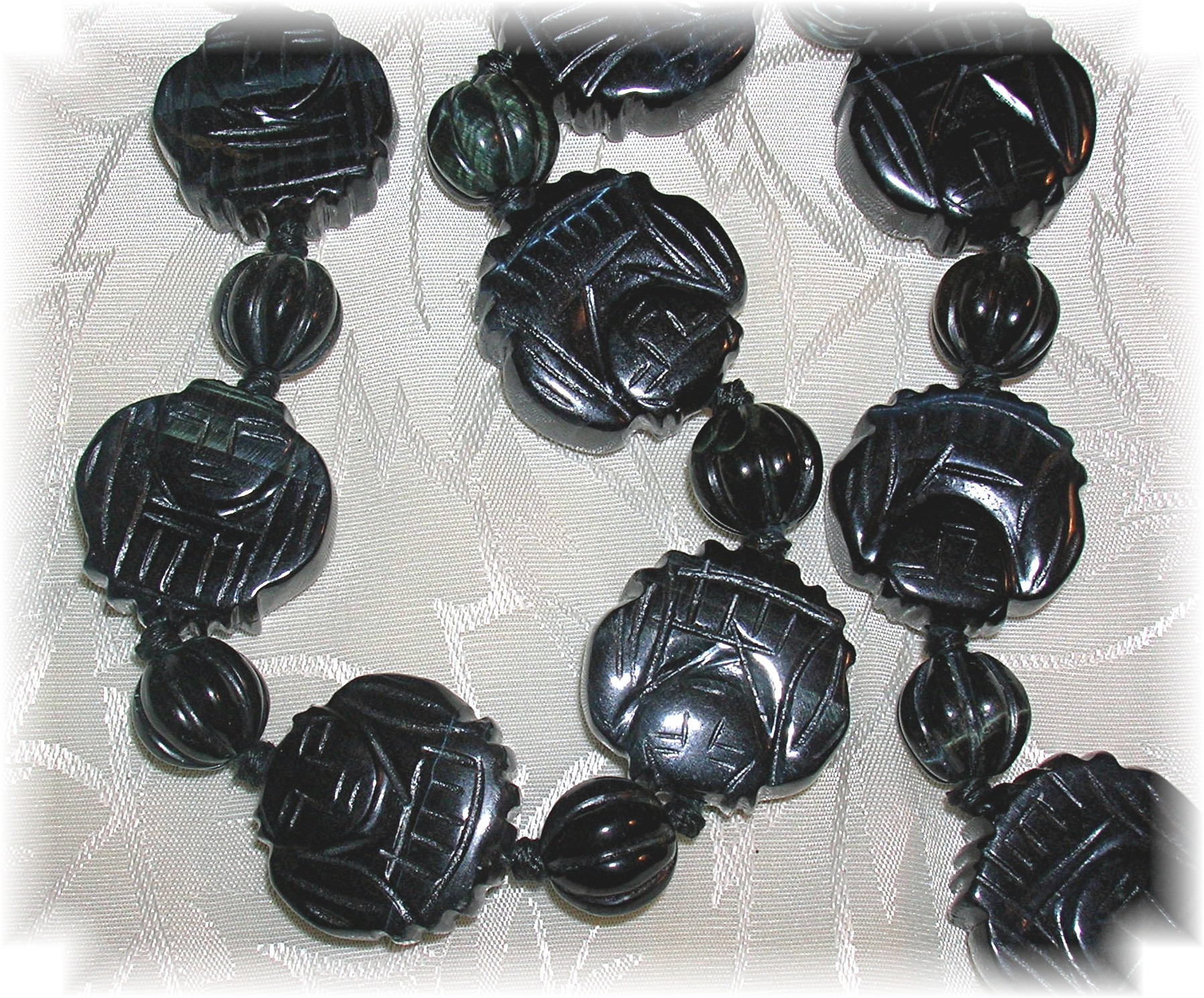 Carved Obsidian Faces 26 Inch Necklace