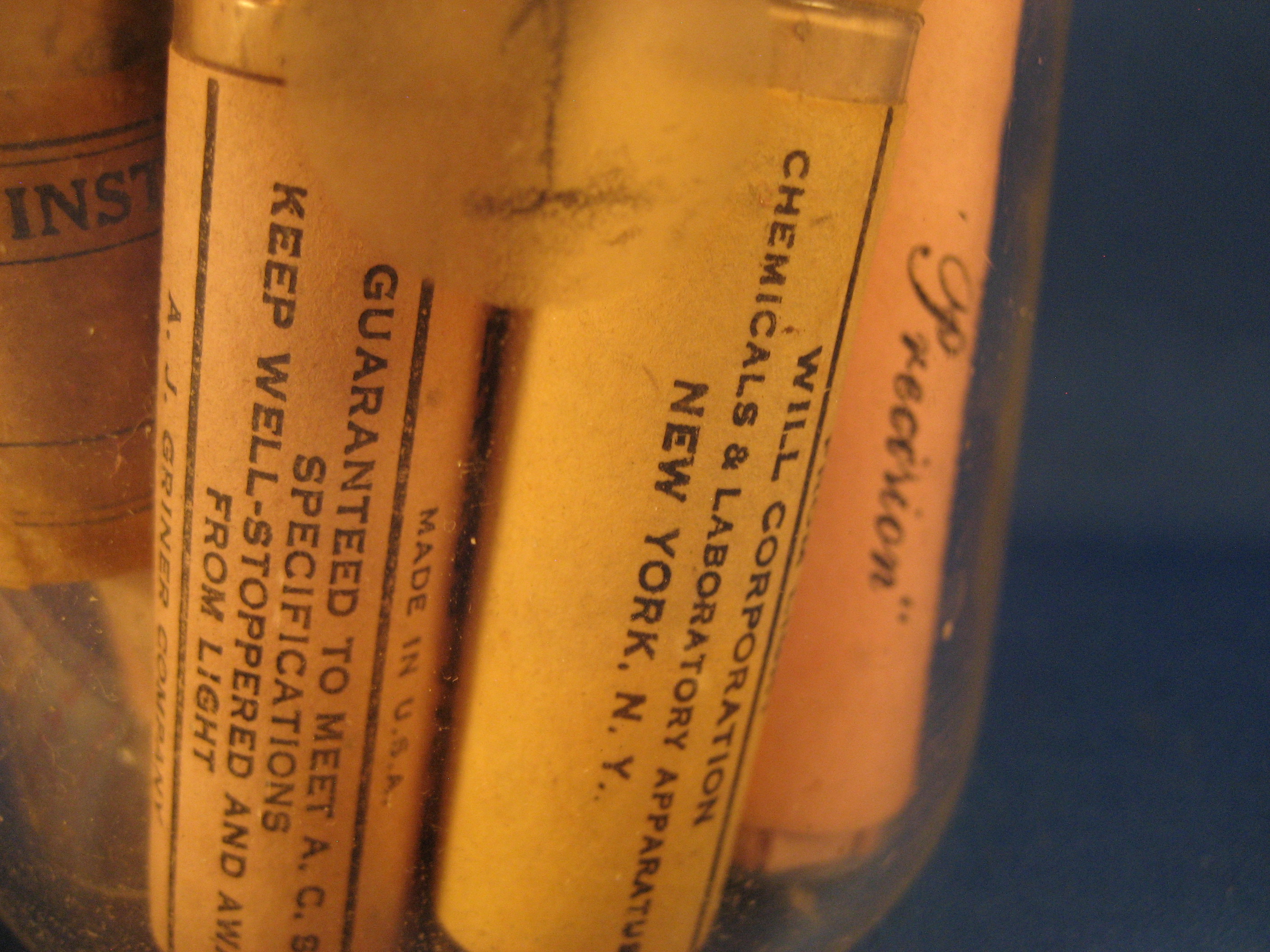 Thirteen Glass Tubes of Litmus Paper and Beaker
