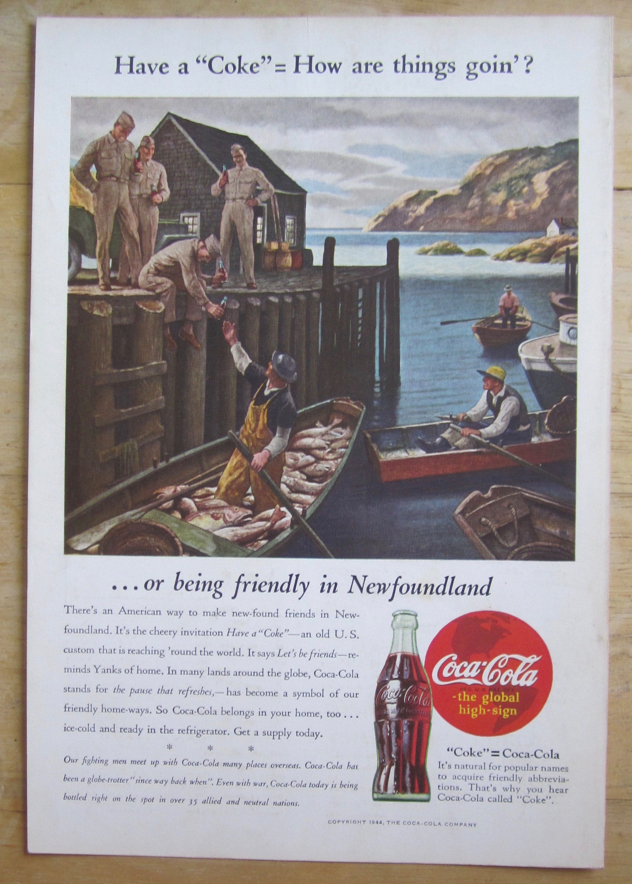 1944 Coca Cola w Soldier Giving Soda To Fisherman