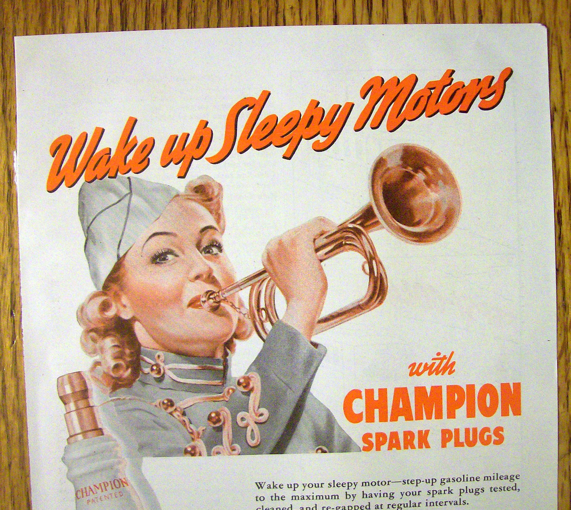 1942 Champion Spark Plugs with Woman Blowing Horn
